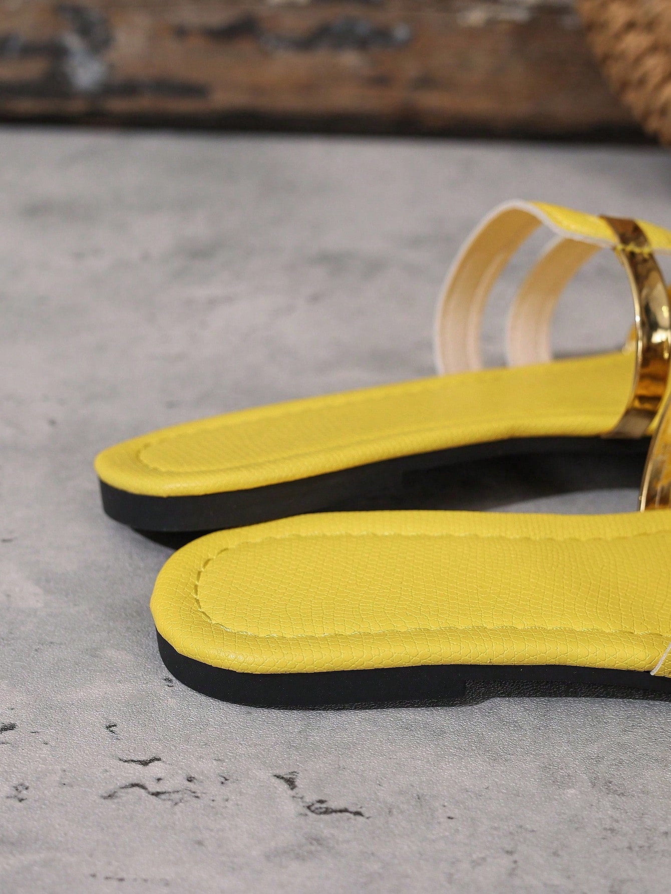 Women's yellow open-toe flat slide sandals featuring a cut-out design and textured plain pattern for casual beach and daily wear.