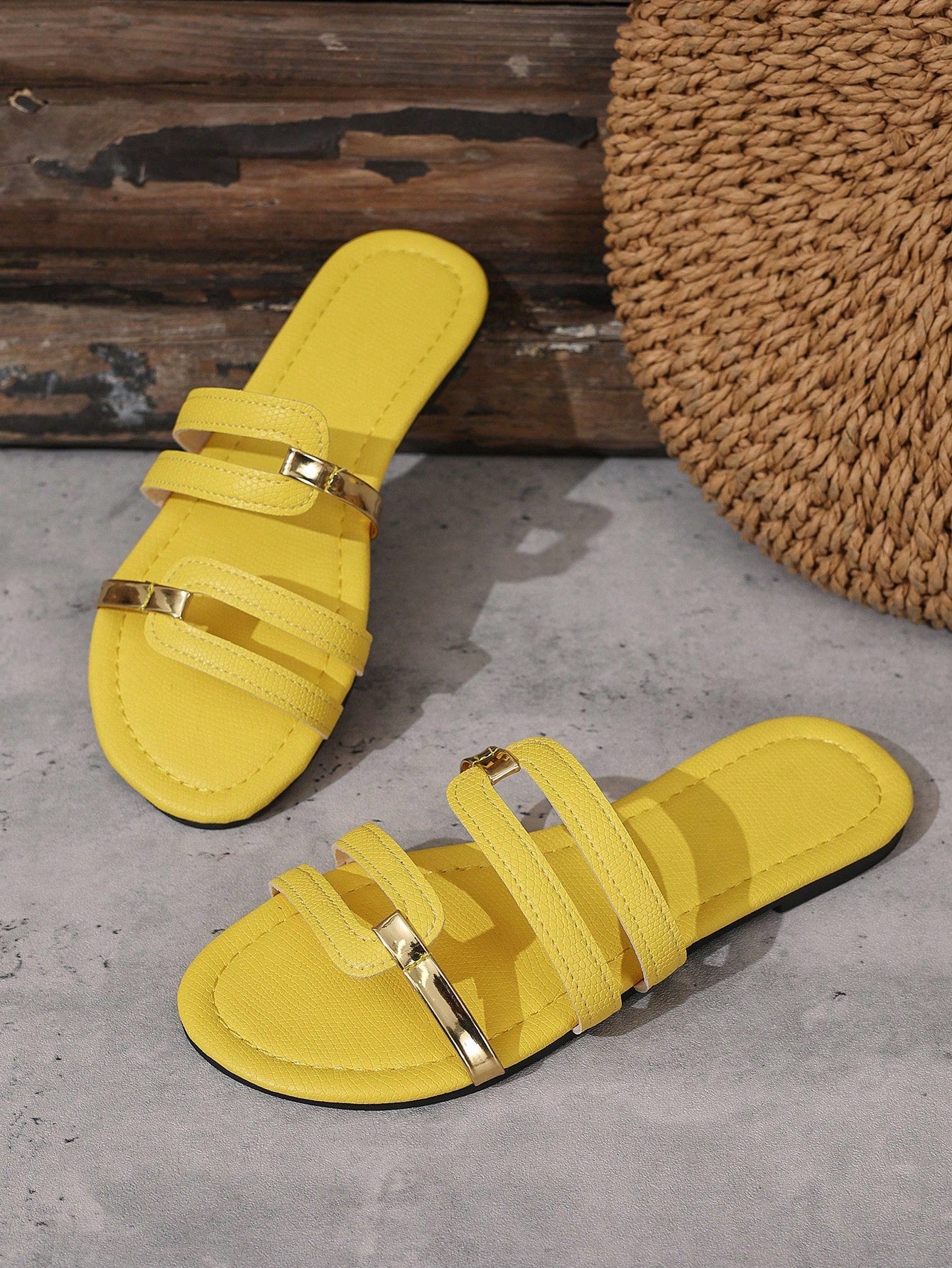 Women's yellow open-toe flat slide sandals featuring a cut-out design and textured plain pattern for casual beach and daily wear.