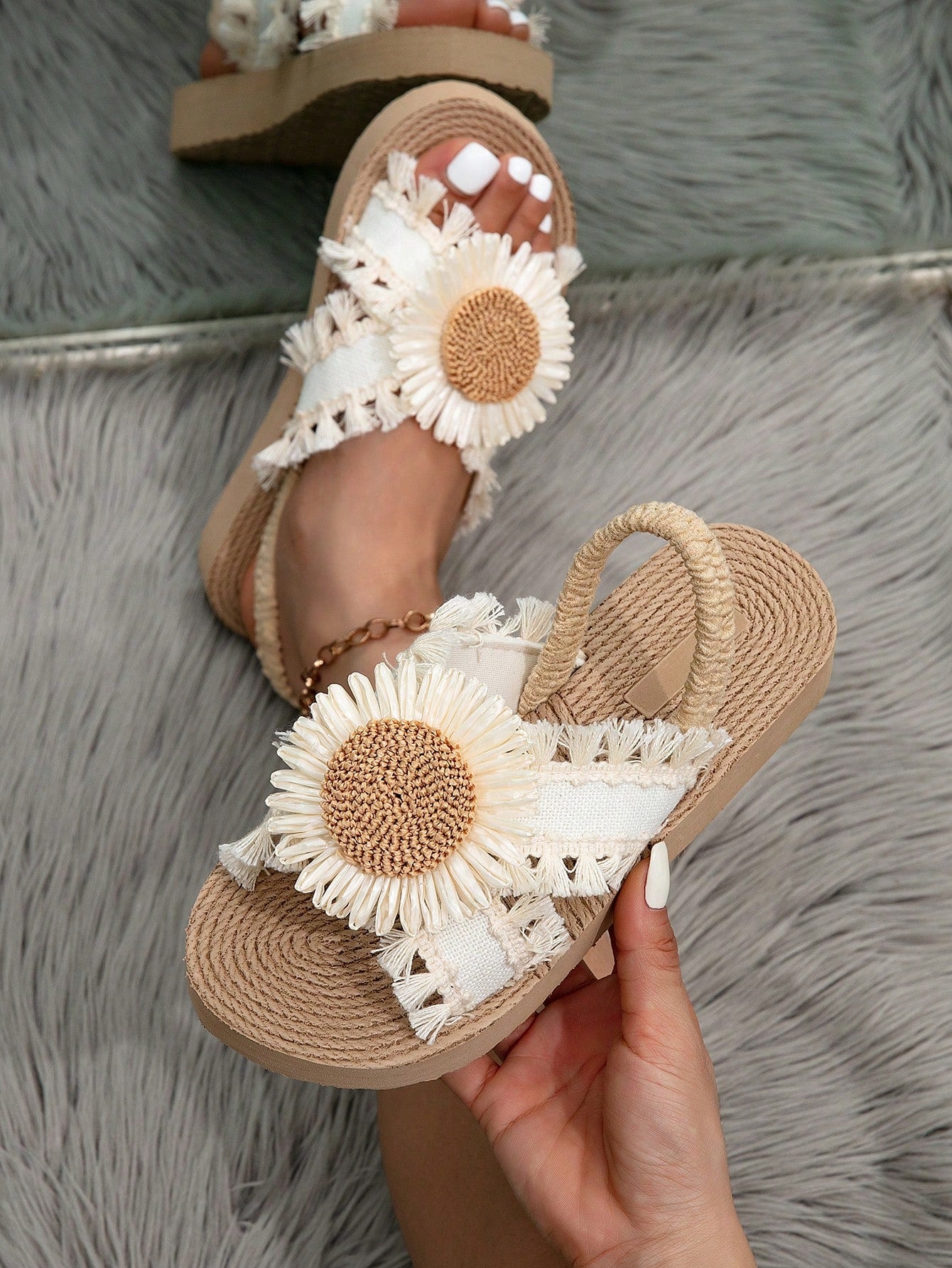 Women's open toe slip-on wedge sandals with criss cross straps and folk-custom styling, featuring raw hem, fringe, tassel, braid, and tape details.