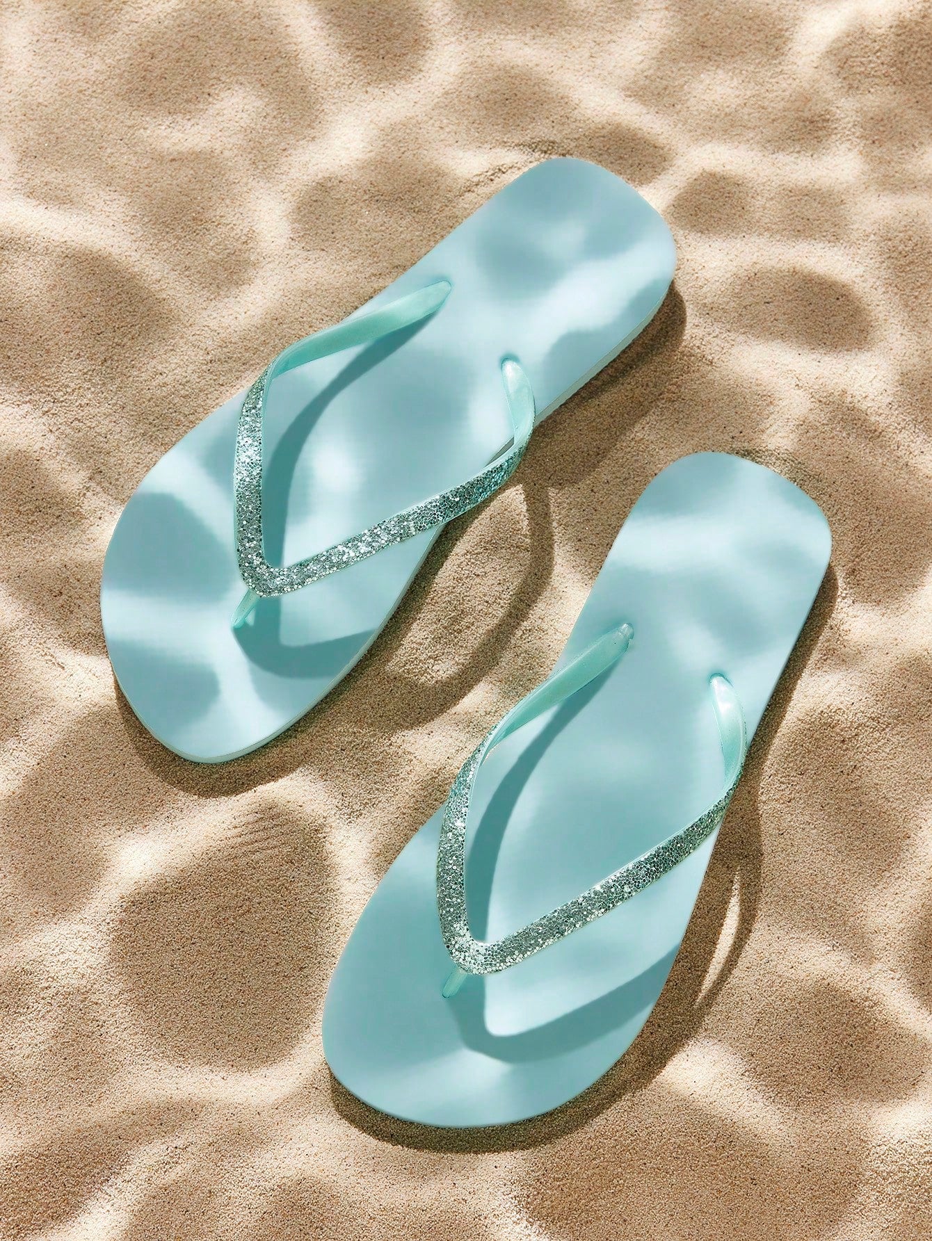 Pair of women’s apricot flat flip-flops with a glitter upper and plain design, suitable for beach, outdoor, home, and vacation wear.