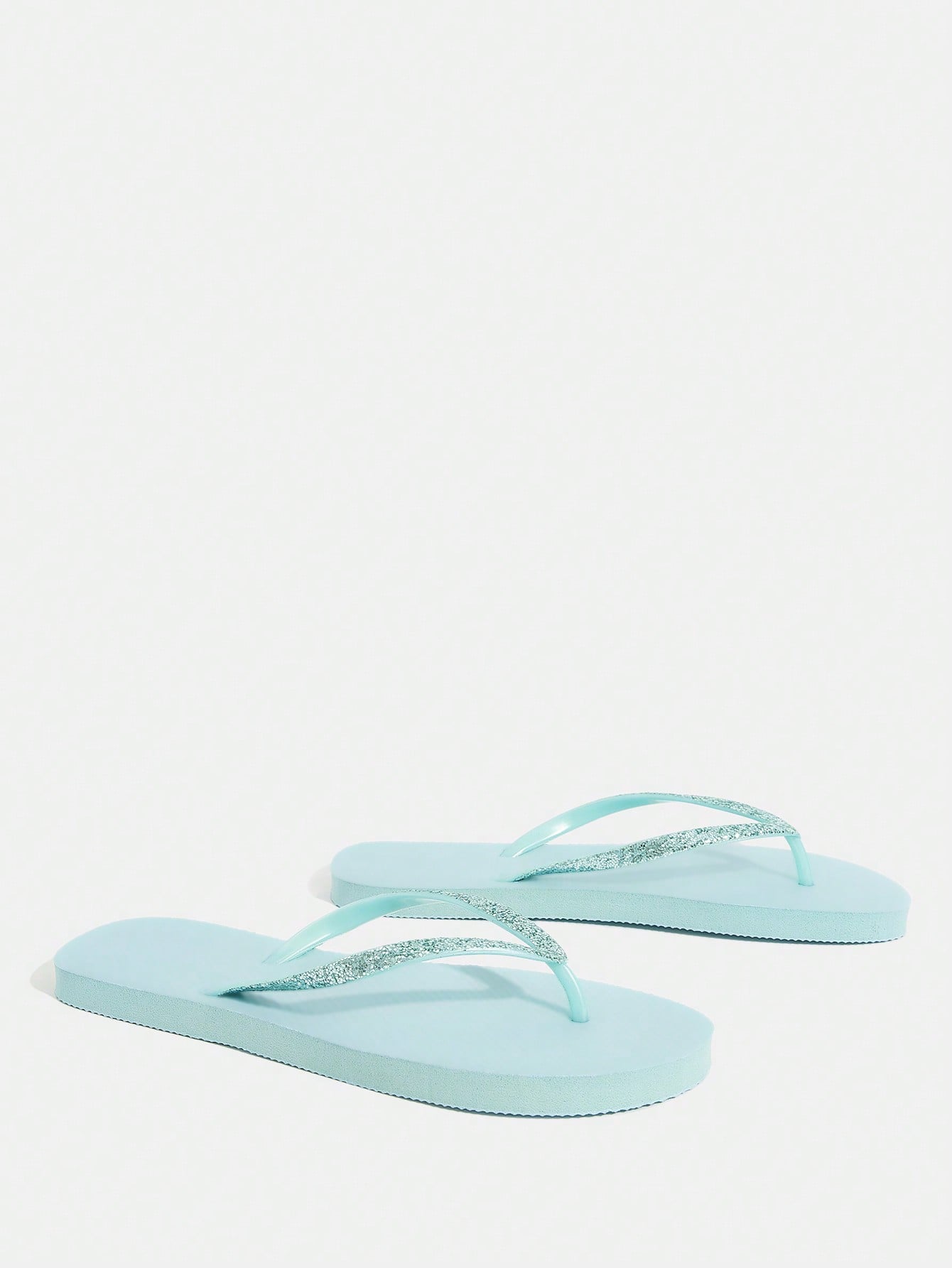 Pair of women’s apricot flat flip-flops with a glitter upper and plain design, suitable for beach, outdoor, home, and vacation wear.
