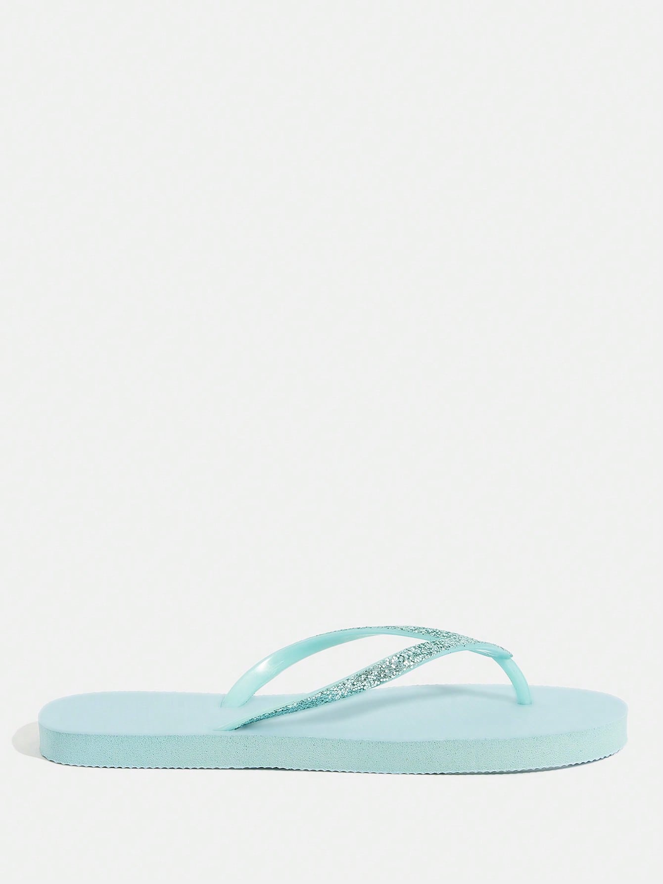Pair of women’s apricot flat flip-flops with a glitter upper and plain design, suitable for beach, outdoor, home, and vacation wear.