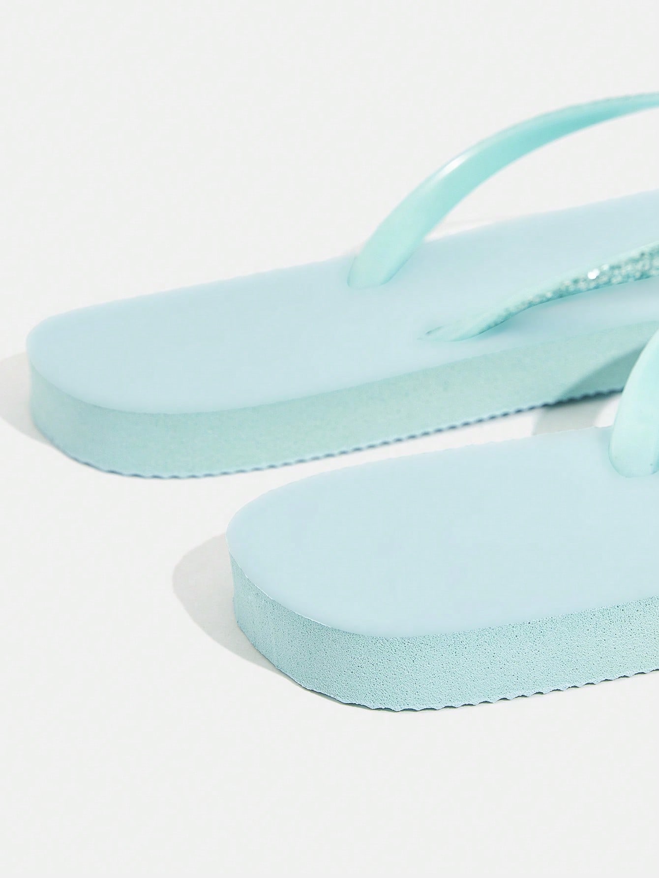 Pair of women’s apricot flat flip-flops with a glitter upper and plain design, suitable for beach, outdoor, home, and vacation wear.