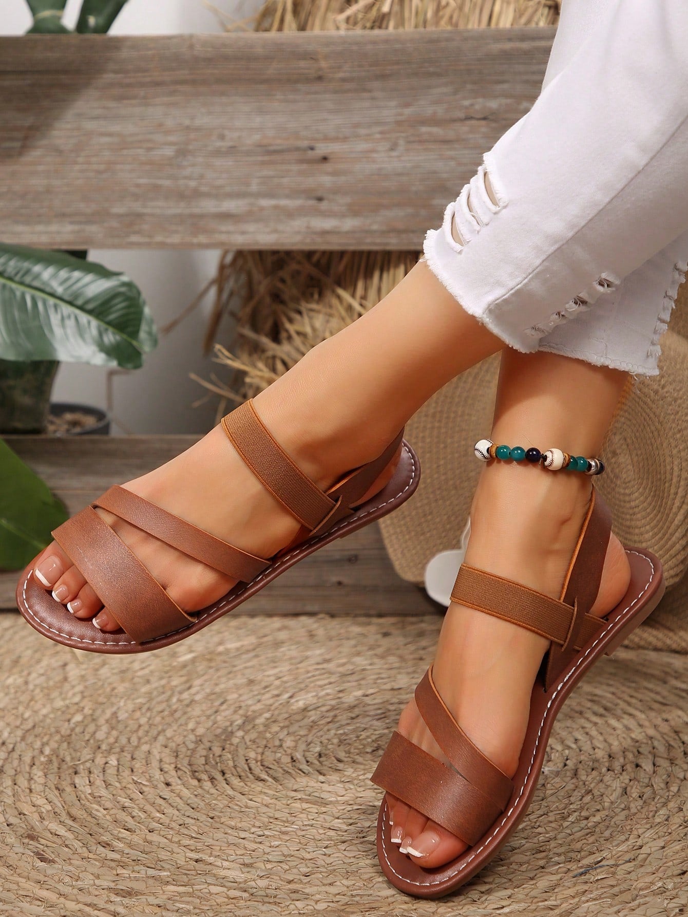 Women’s flat slide sandals with cut-out Roman-style straps and open-toe design, suitable for casual beach and home wear.