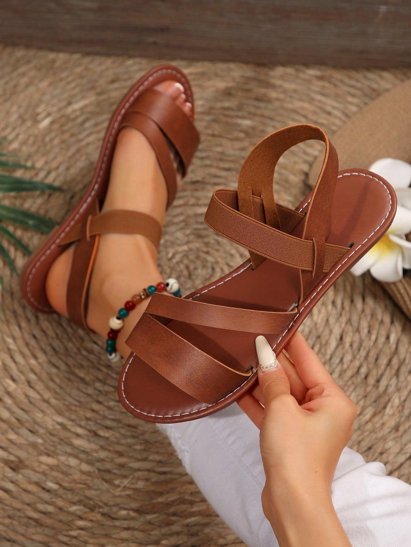 Women’s flat slide sandals with cut-out Roman-style straps and open-toe design, suitable for casual beach and home wear.