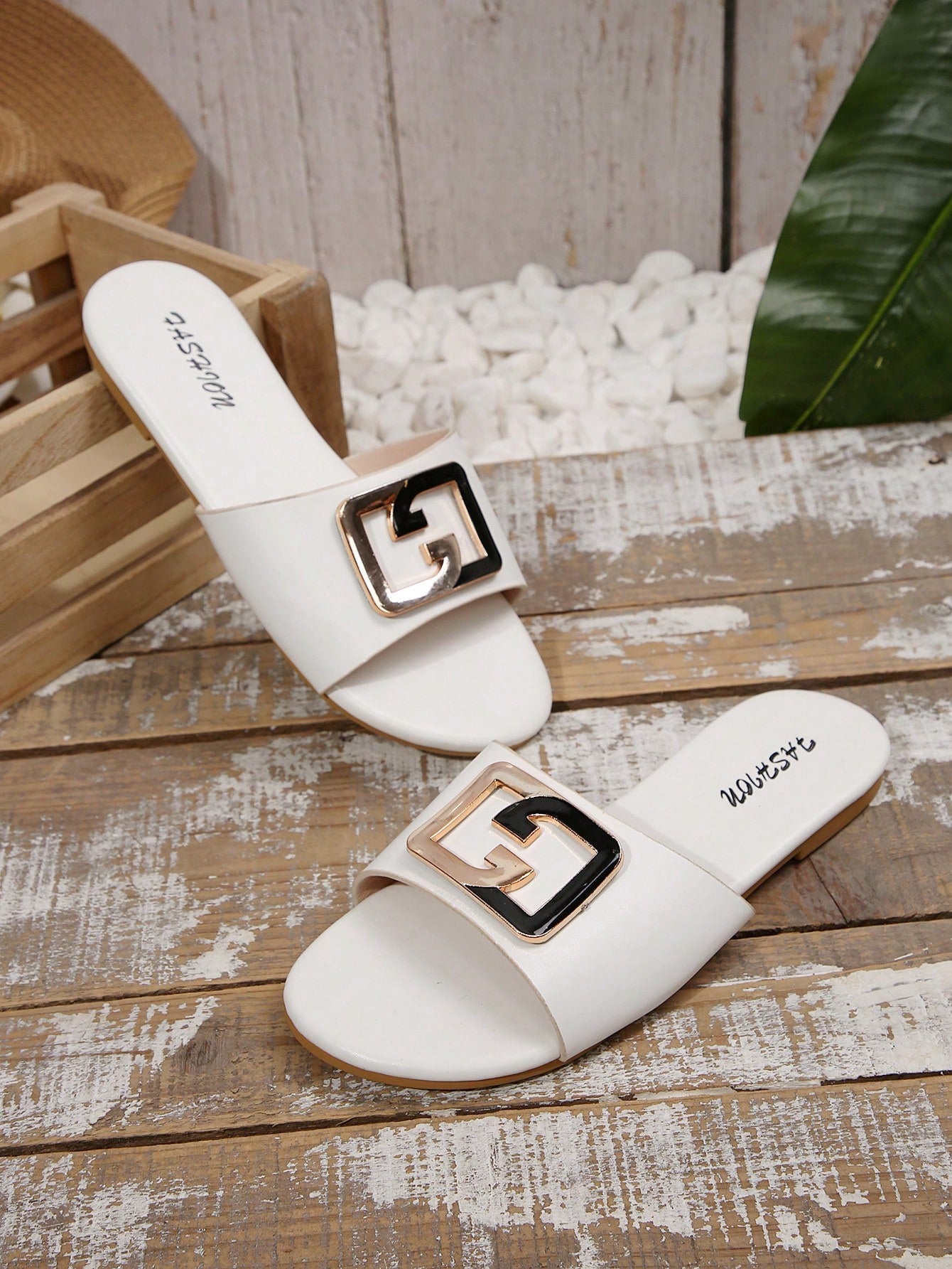 Pair of women's black flat slide sandals featuring rhinestone embellishments, metal accents, and a gold-strip detail on the upper, with an open-toe slip-on design.