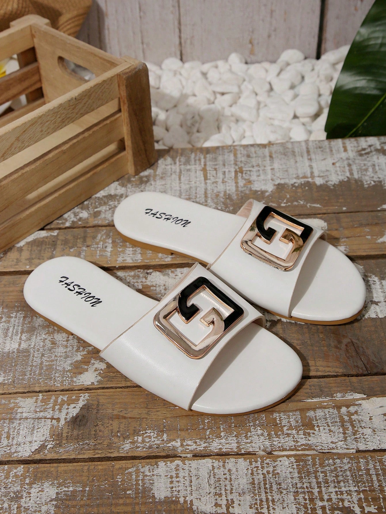 Pair of women's black flat slide sandals featuring rhinestone embellishments, metal accents, and a gold-strip detail on the upper, with an open-toe slip-on design.
