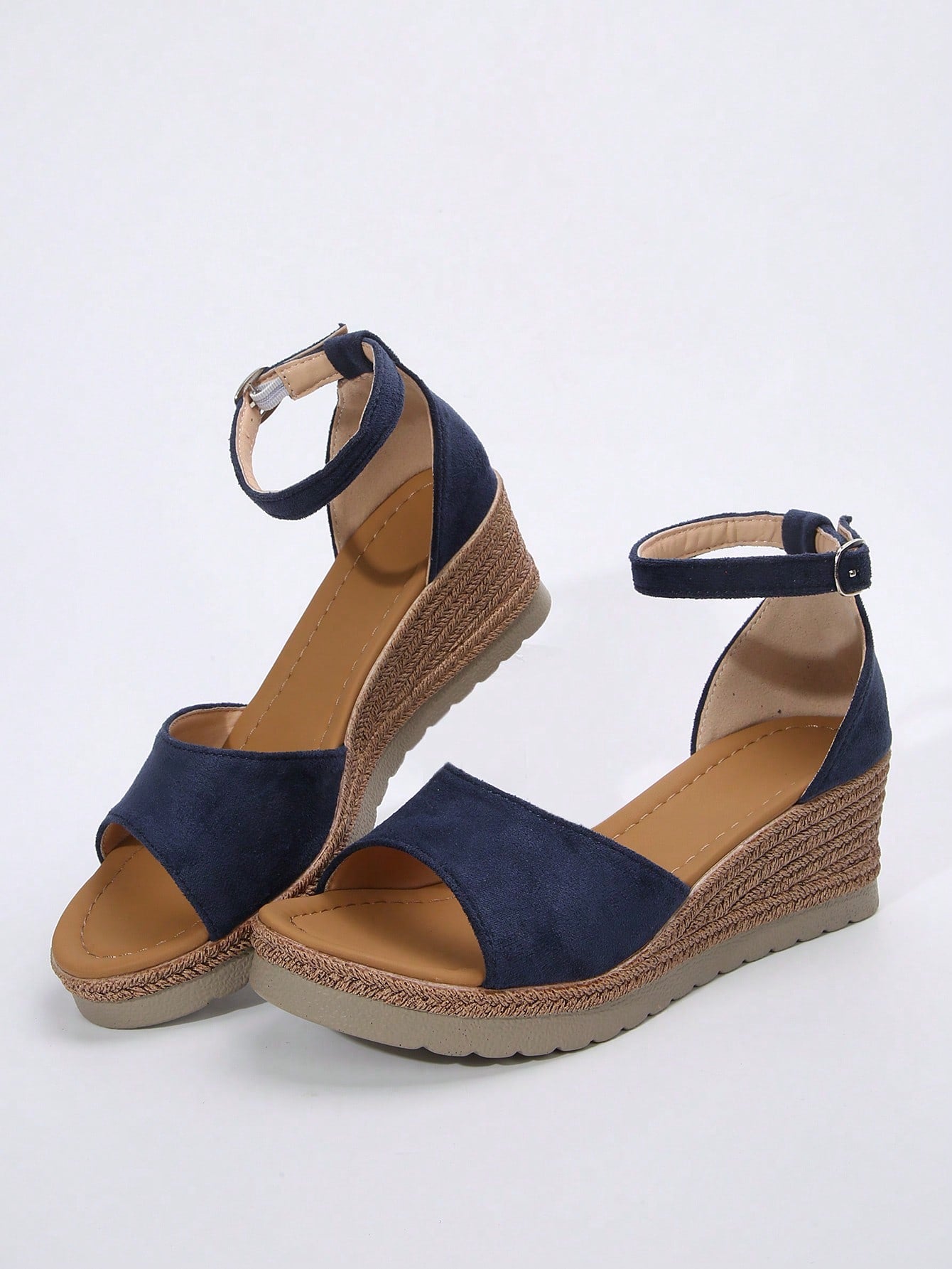 Women's classic wedge sandals featuring a peep open toe, ankle strap with buckle closure, mid wedge heel, and large bow detail in a bohemian beach style.