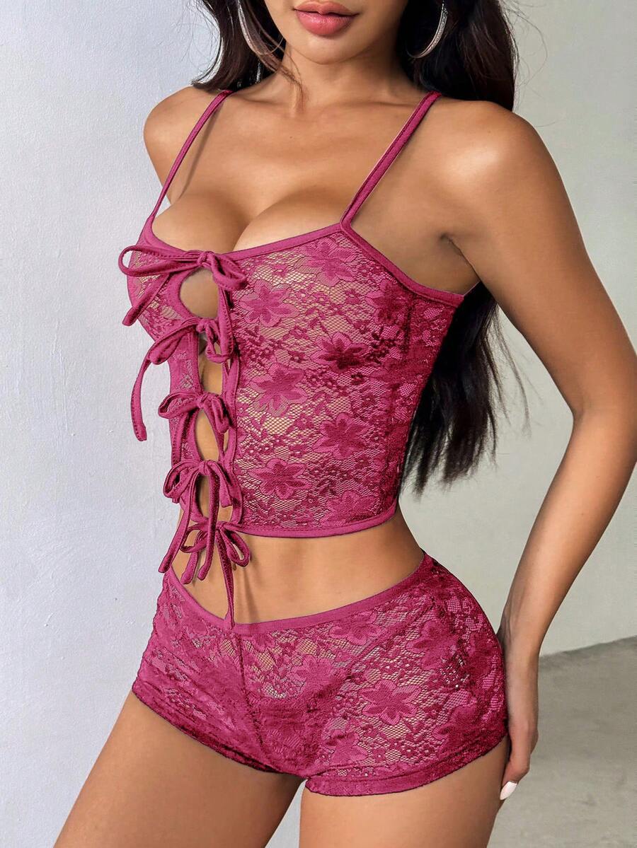 Semi-sheer lace two-piece set with a crop spaghetti strap tank top, cold shoulder cutouts, lace-up details, and matching shorts.