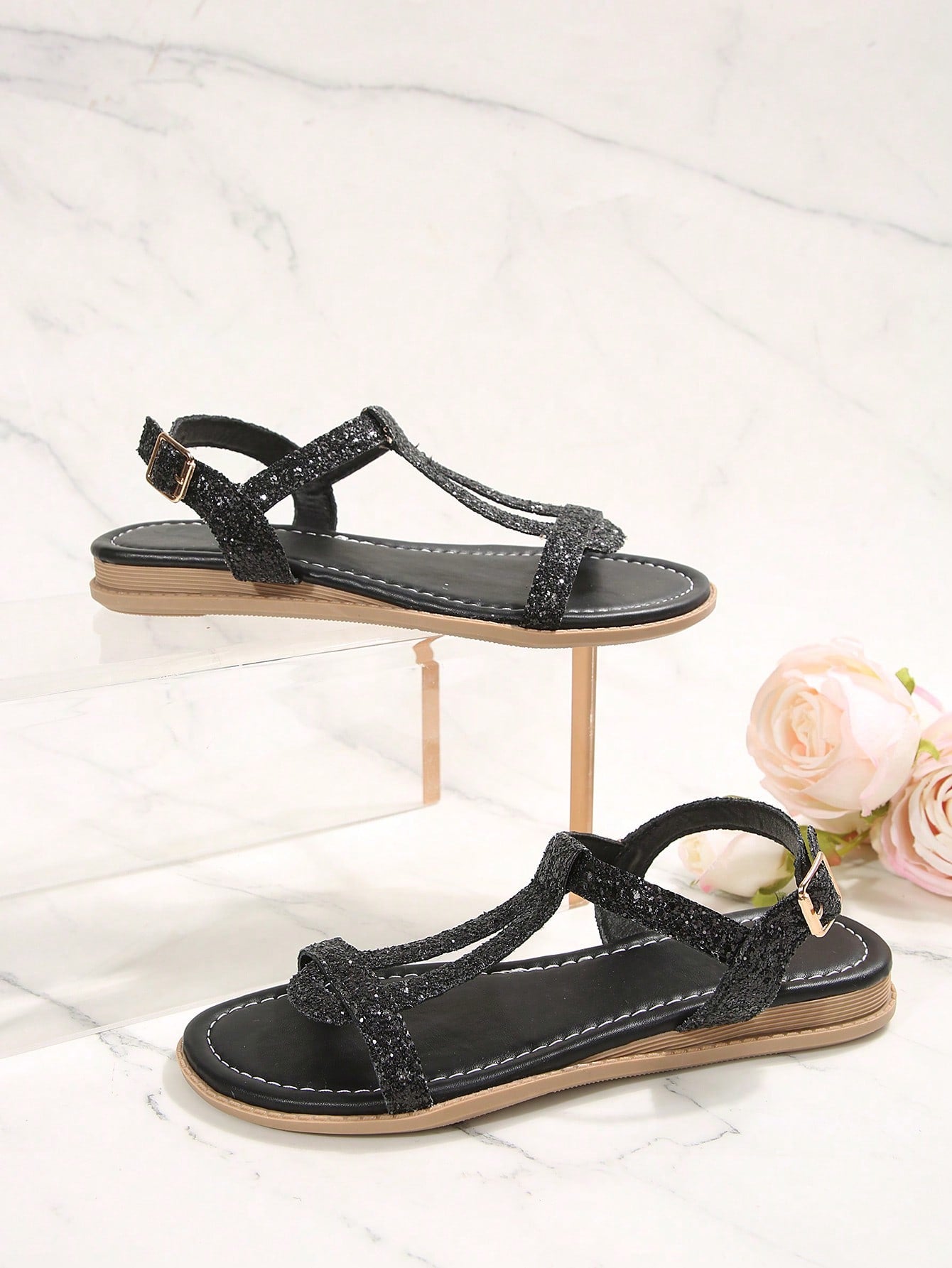 Women’s flat sandals with multiple straps, open toe front, and ankle strap buckle, featuring a plain design with glitter accents in a beach vacation style.