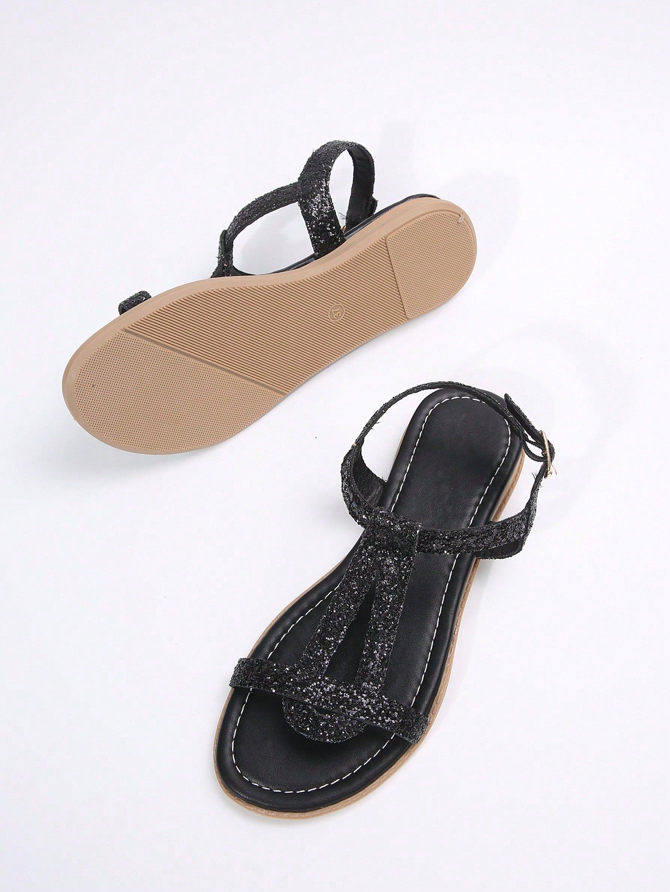 Women’s flat sandals with multiple straps, open toe front, and ankle strap buckle, featuring a plain design with glitter accents in a beach vacation style.
