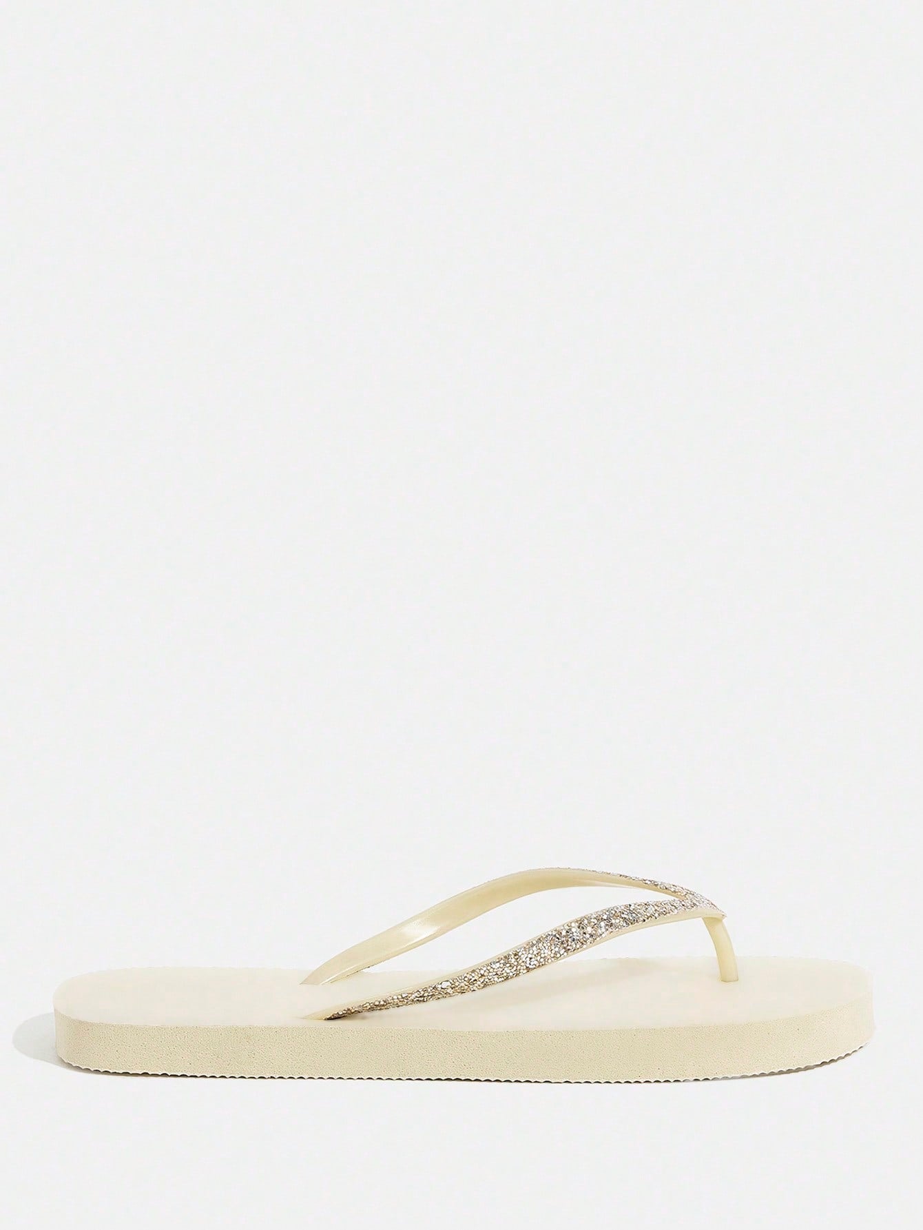 Pair of women’s apricot flat flip-flops with a glitter upper and plain design, suitable for beach, outdoor, home, and vacation wear.