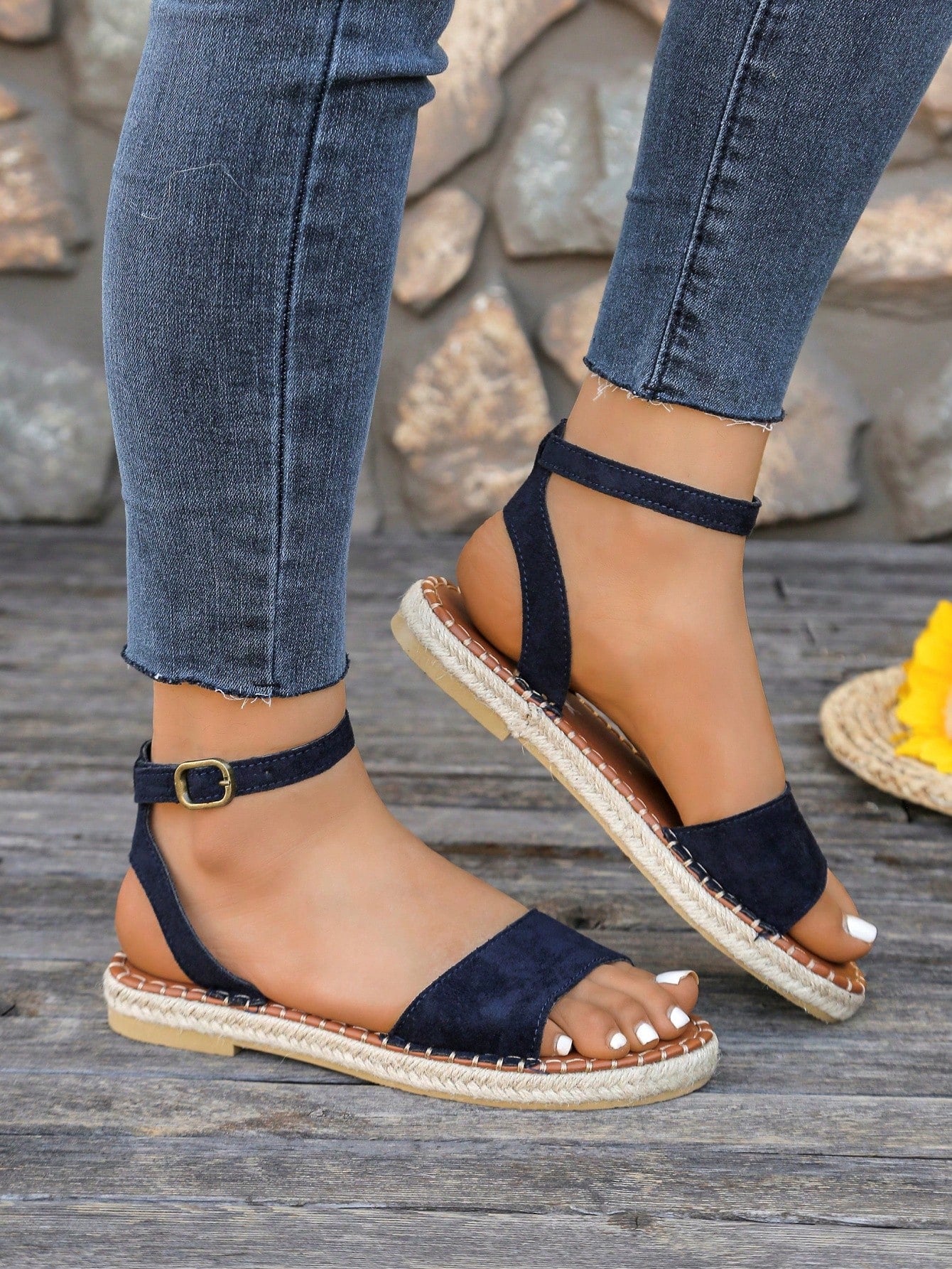 Women's woven Roman slide sandals with buckle detail, flat sole, and open-toe design for casual outdoor wear.