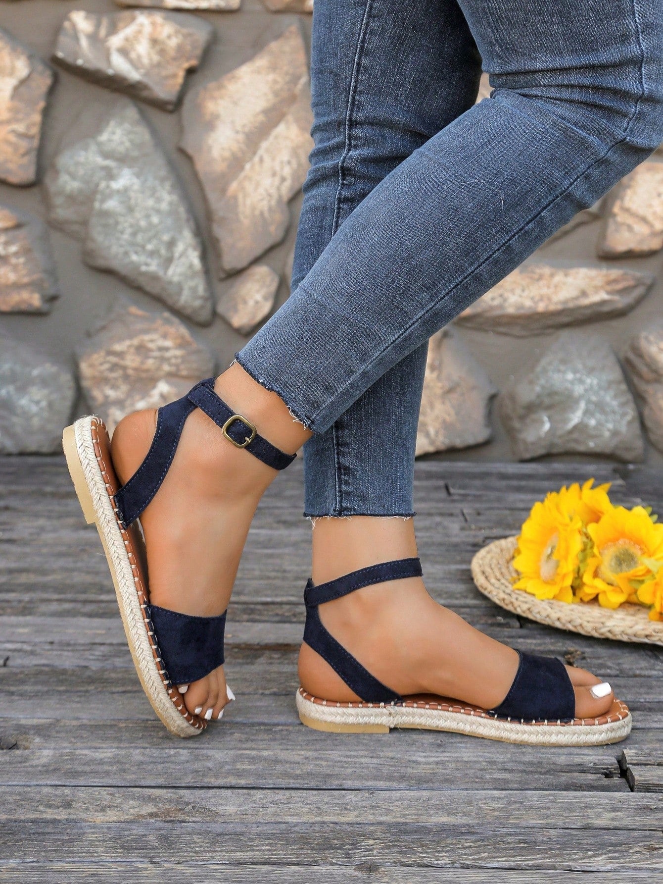 Women's woven Roman slide sandals with buckle detail, flat sole, and open-toe design for casual outdoor wear.