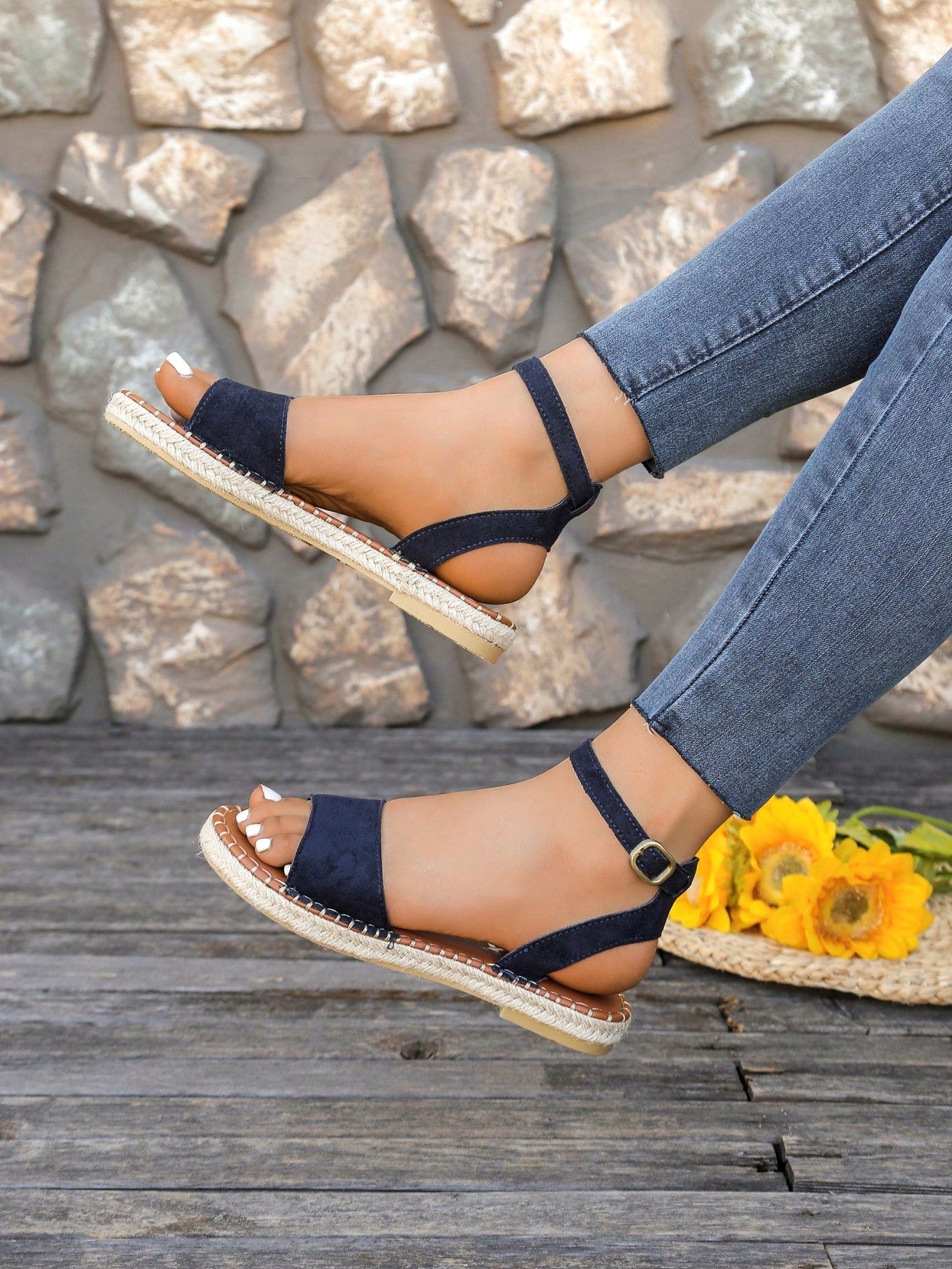 Women's woven Roman slide sandals with buckle detail, flat sole, and open-toe design for casual outdoor wear.