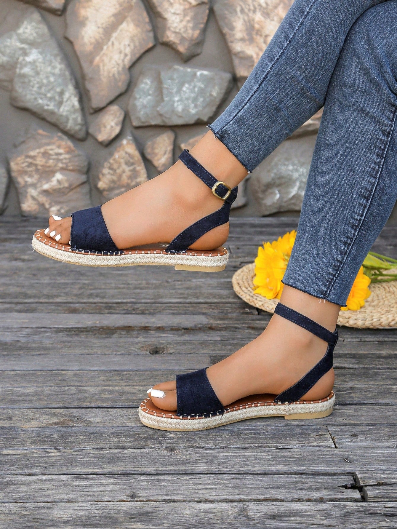 Women's woven Roman slide sandals with buckle detail, flat sole, and open-toe design for casual outdoor wear.