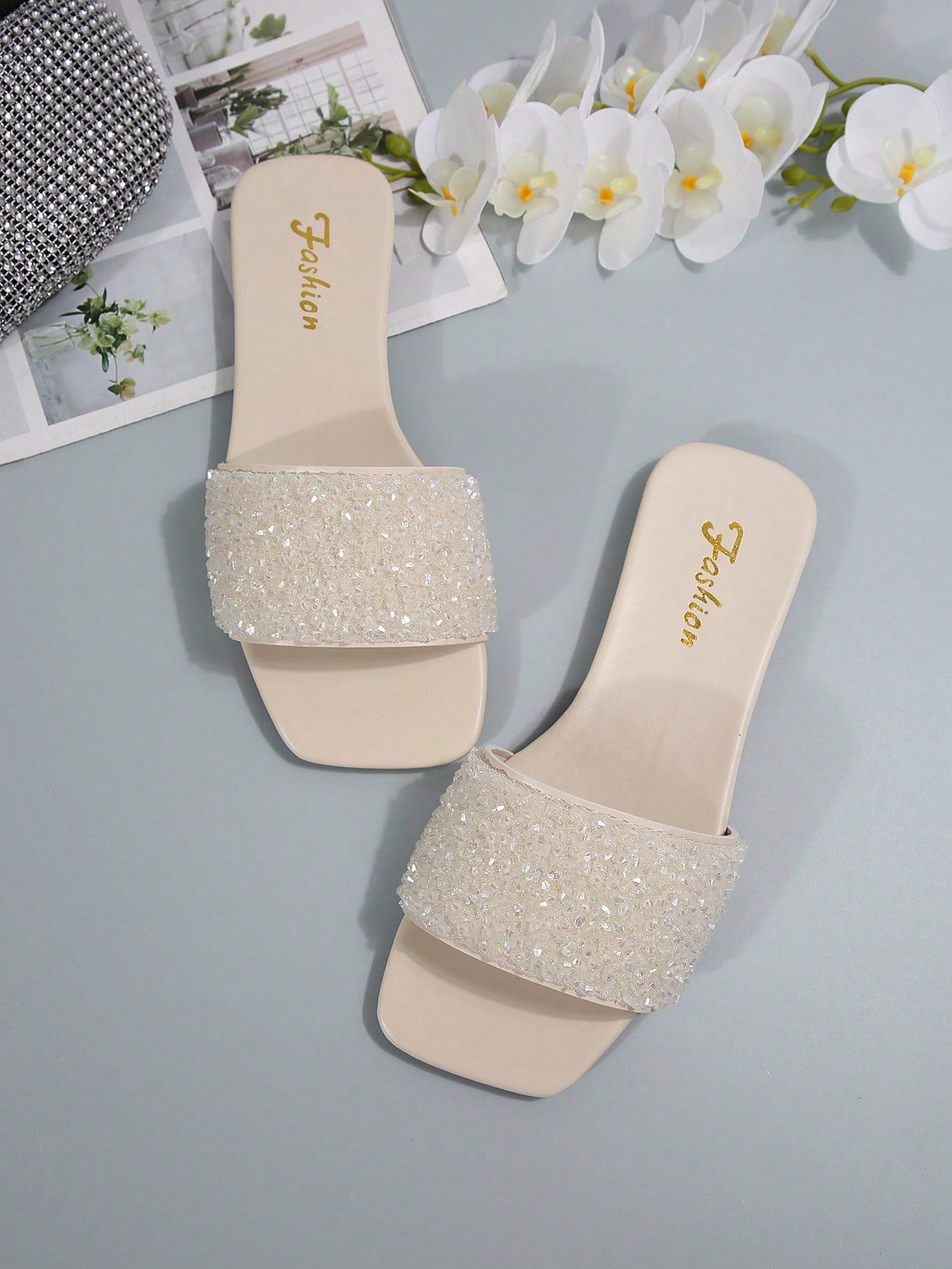 Women's flat slide sandals with rhinestone-decorated straps and open toe, casual outdoor style with plain design.