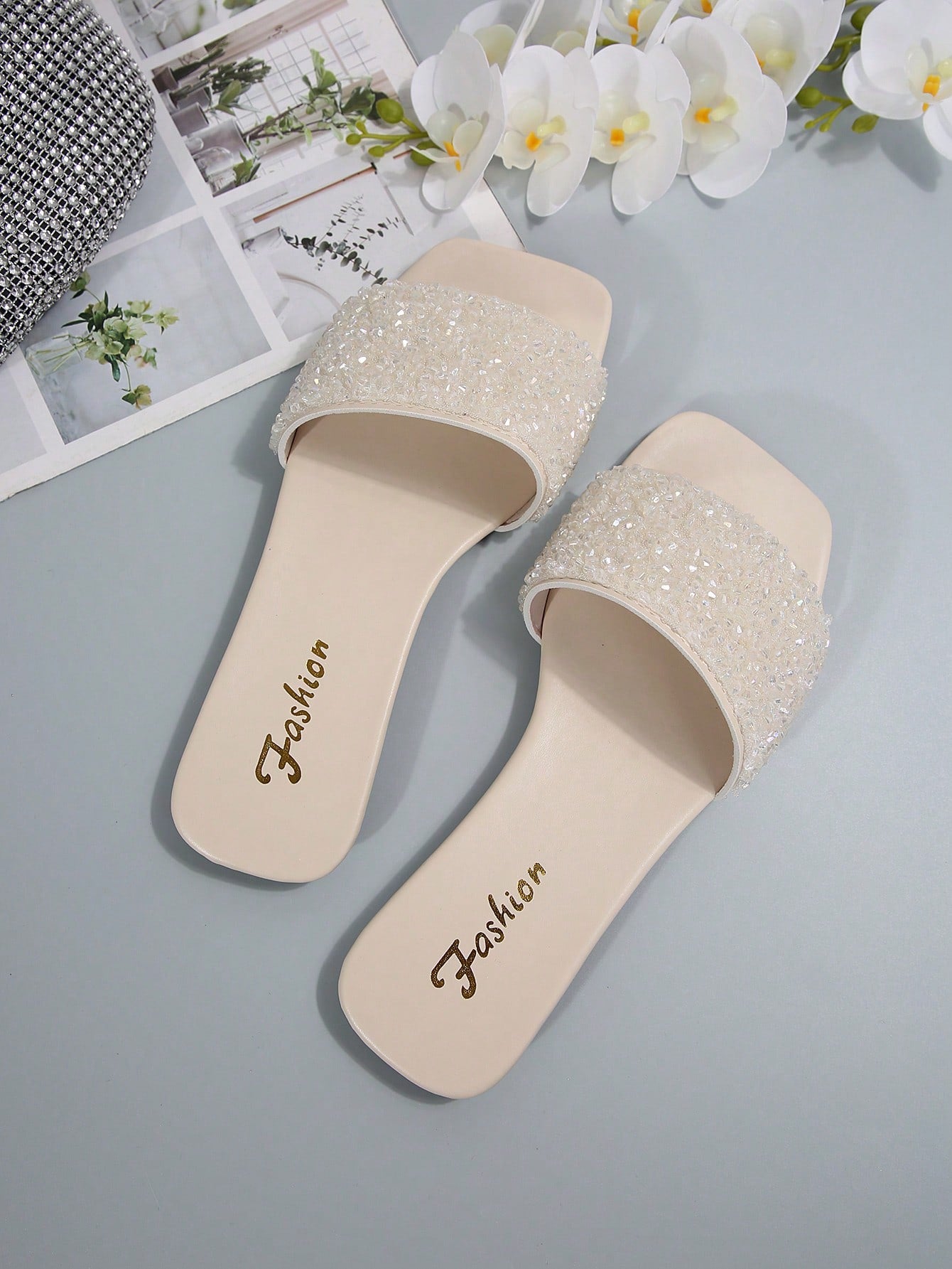 Women's flat slide sandals with rhinestone-decorated straps and open toe, casual outdoor style with plain design.