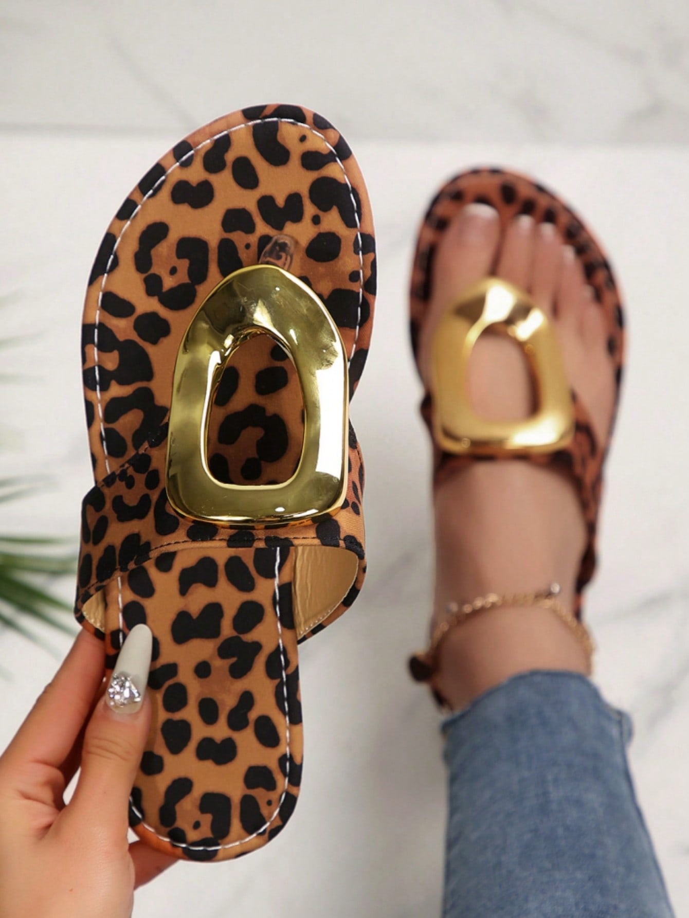 Women's leopard print slip-on flat slide sandals with metal buckle decor, fabric upper, and open slide design for outdoor wear.