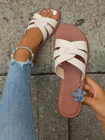 Beige women’s open-toe flat slide sandals with embossed animal pattern and metallic decor, casual beach style