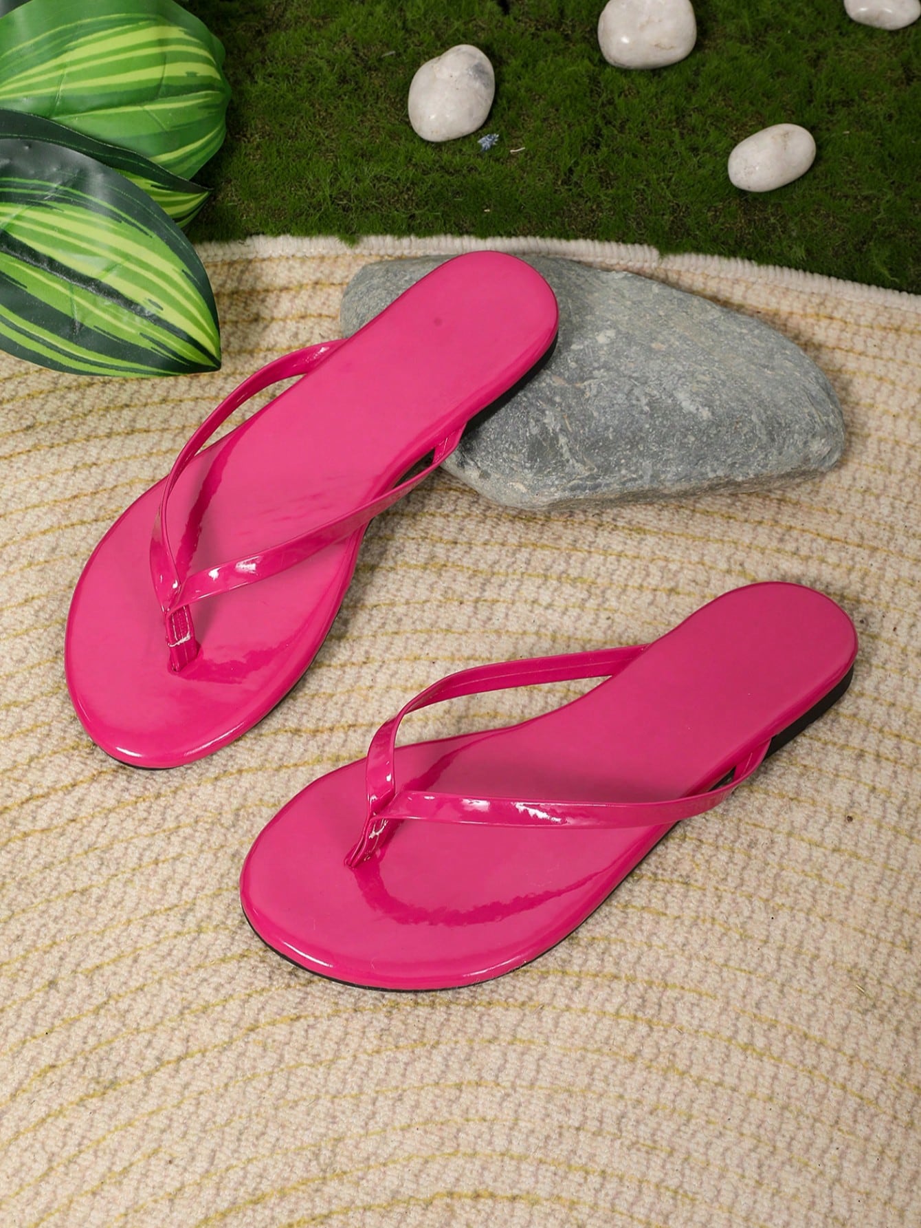 Women's flat flip-flop sandals with open toe and woven Roman-style upper in slip-on design.