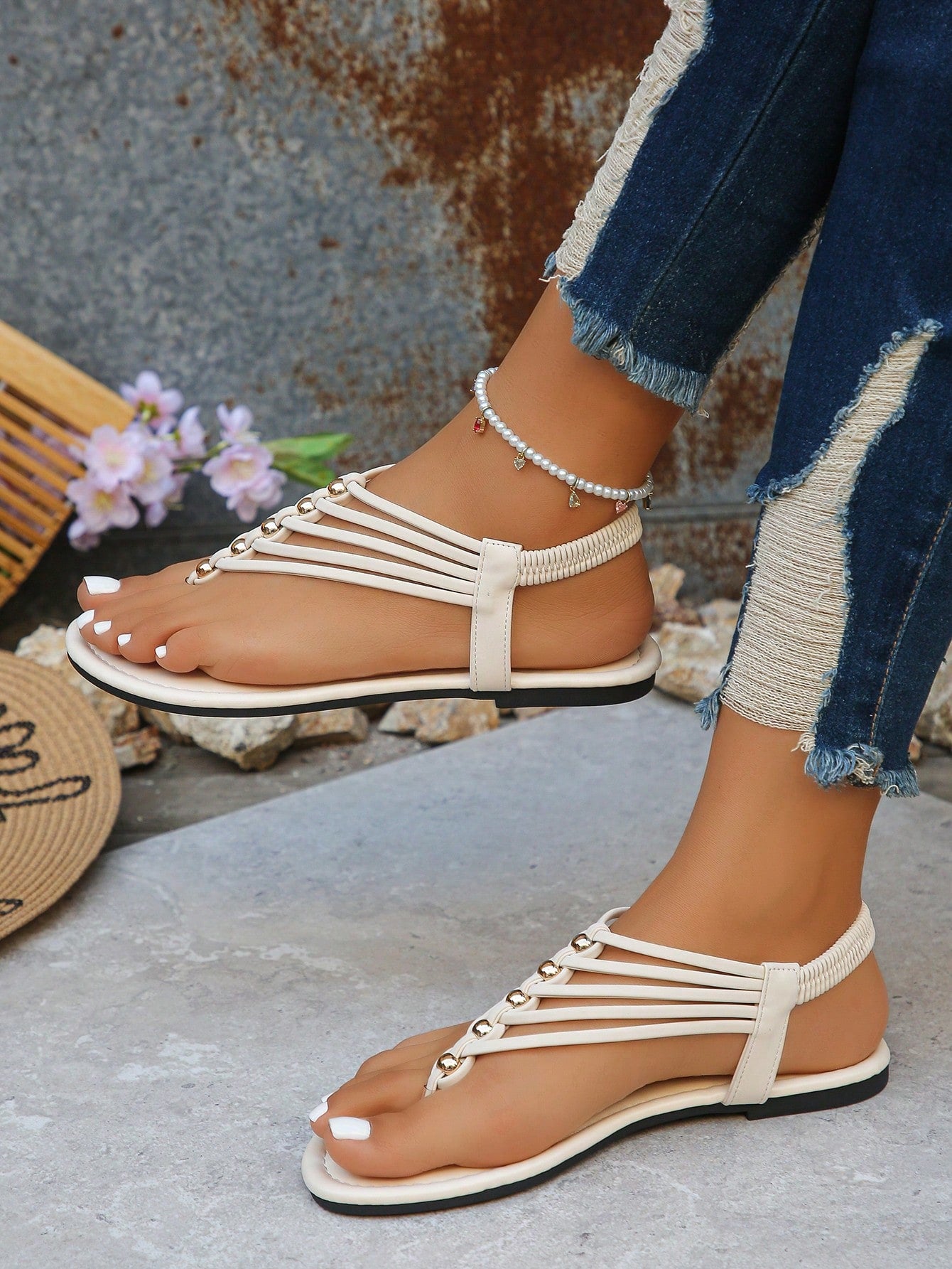 Women's boho flat sandals with elastic straps, braided beaded criss-cross detail, and toe post in gladiator style, suitable for beach, party, and outdoor summer wear.
