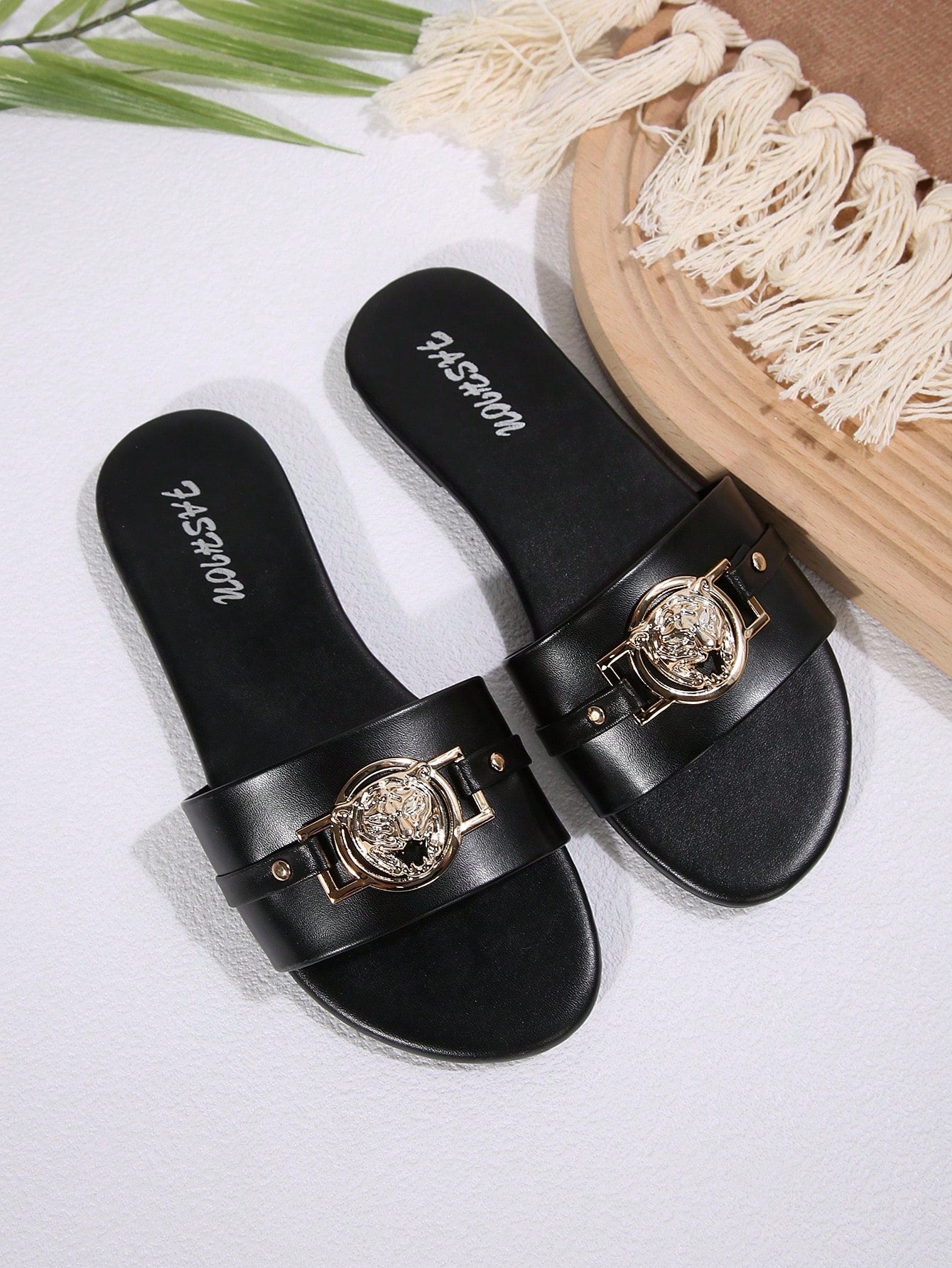 Pair of women's black flat slide sandals featuring rhinestone embellishments, metal accents, and a gold-strip detail on the upper, with an open-toe slip-on design.