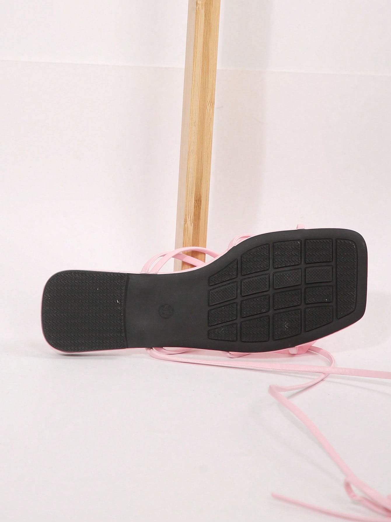 Women's flat slide sandals with open toe, floral applique detail, and criss-cross straps, shown as casual vacation-style summer footwear.