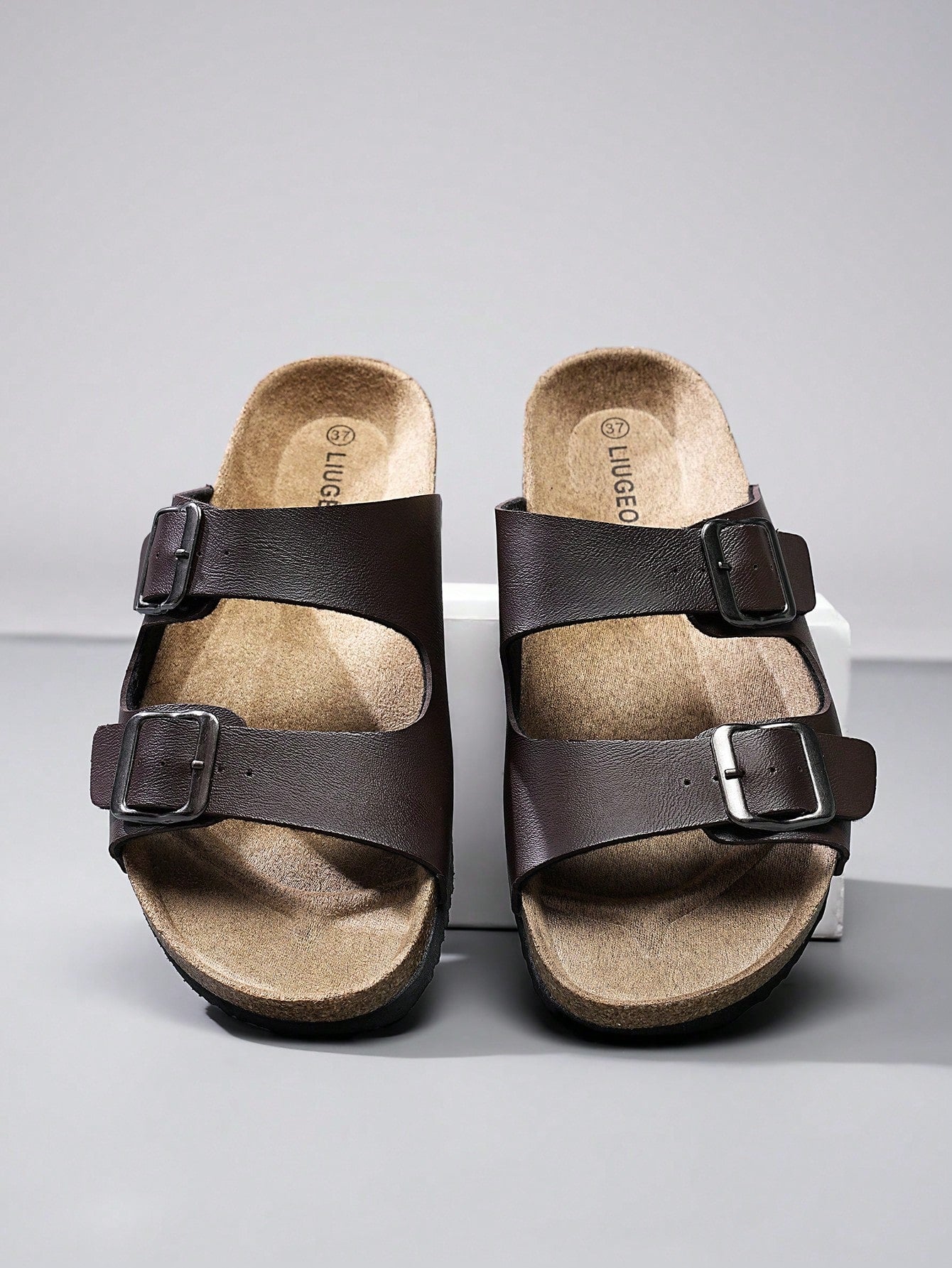 Open-toe footbed slip-on mule sandals with buckle detail and cork-style sole, flat heel design for casual summer home and outdoor walking.