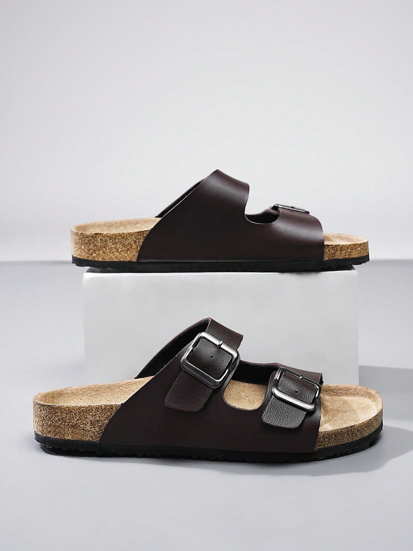 Open-toe footbed slip-on mule sandals with buckle detail and cork-style sole, flat heel design for casual summer home and outdoor walking.
