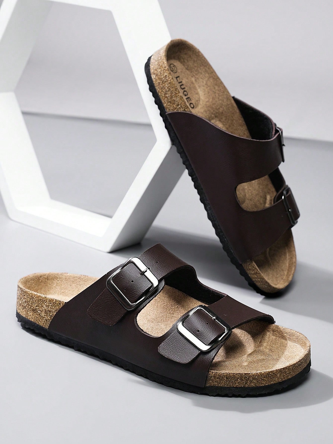 Open-toe footbed slip-on mule sandals with buckle detail and cork-style sole, flat heel design for casual summer home and outdoor walking.