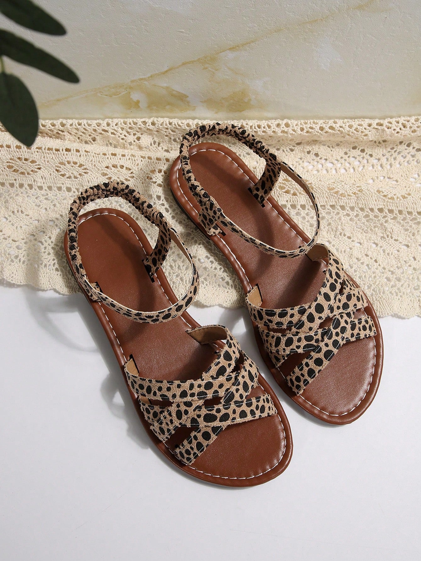 Women's flat thick sole gladiator sandals with cross adjustable straps and open toe, suitable for casual, vacation, and beach wear.