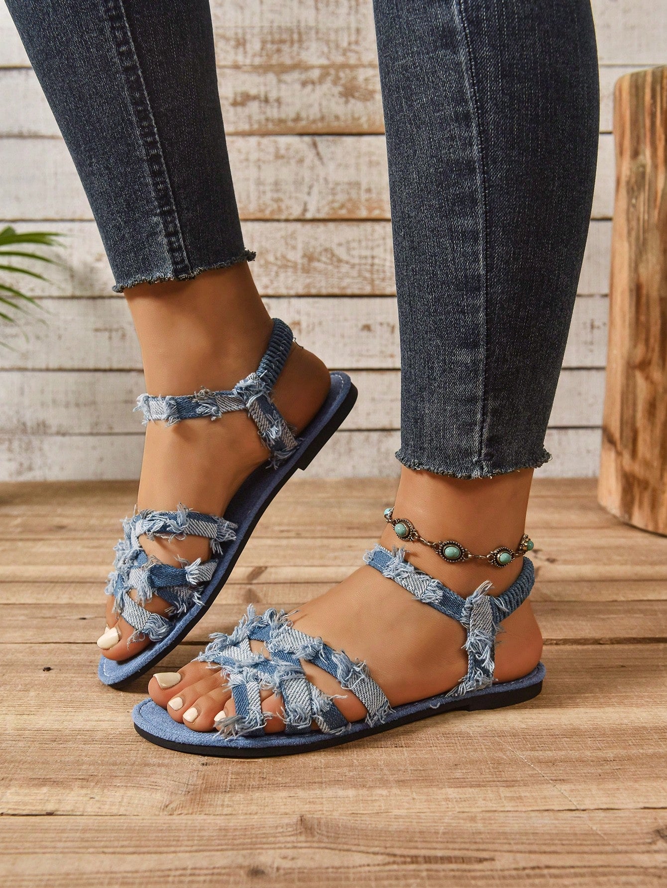 Women’s blue flat gladiator sandals with buckle and criss cross straps, round toe, and plaid pattern, styled as casual woven beach slippers.