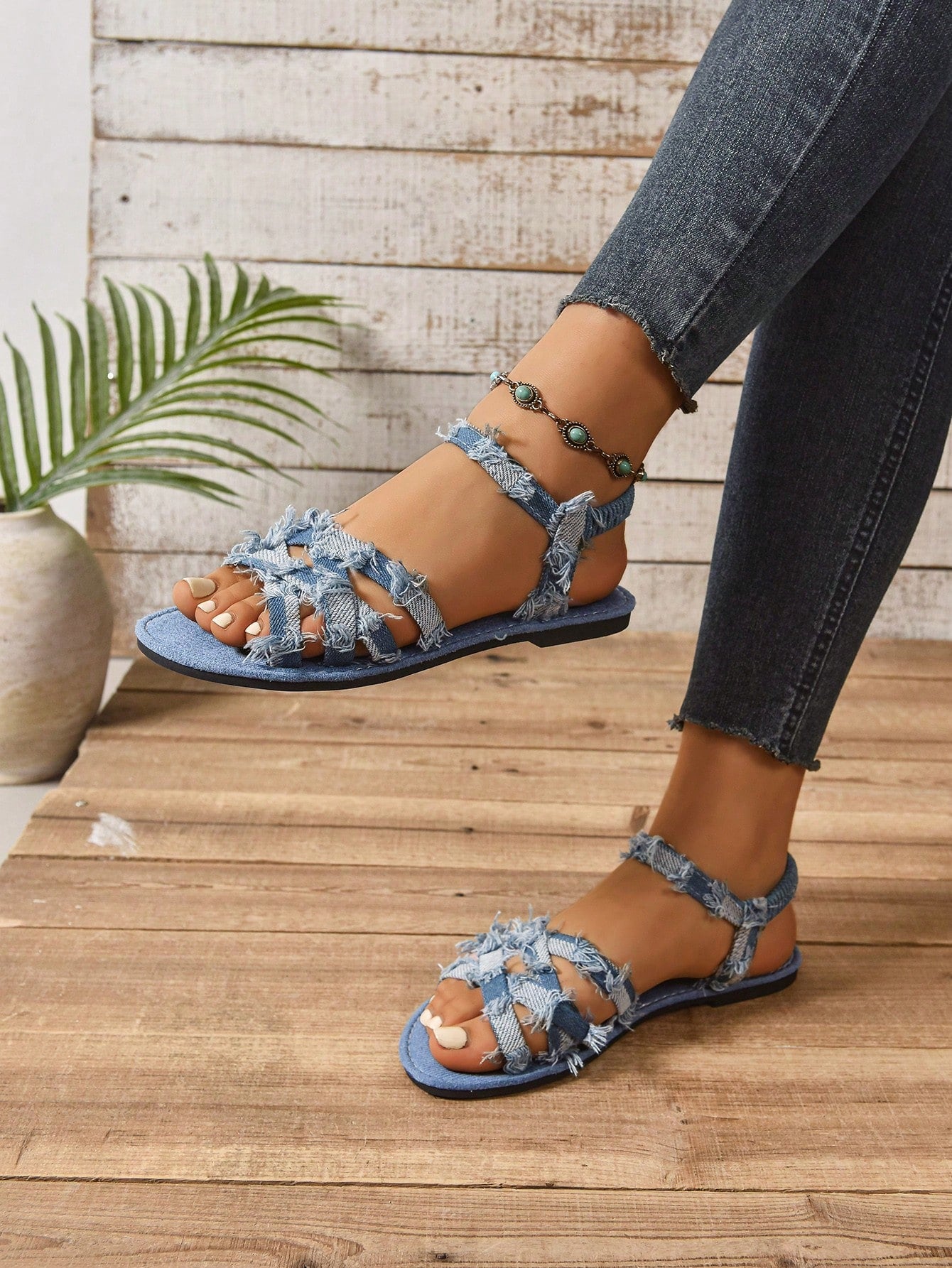 Women’s blue flat gladiator sandals with buckle and criss cross straps, round toe, and plaid pattern, styled as casual woven beach slippers.