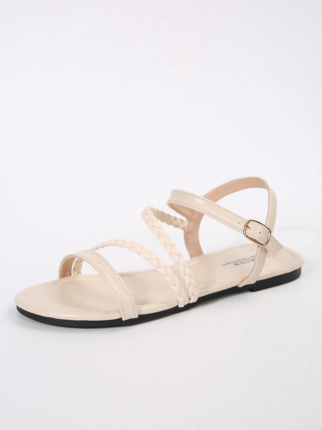 Pair of women’s plus size flat gladiator sandals with woven braid straps, snake pattern look, and open toe design.
