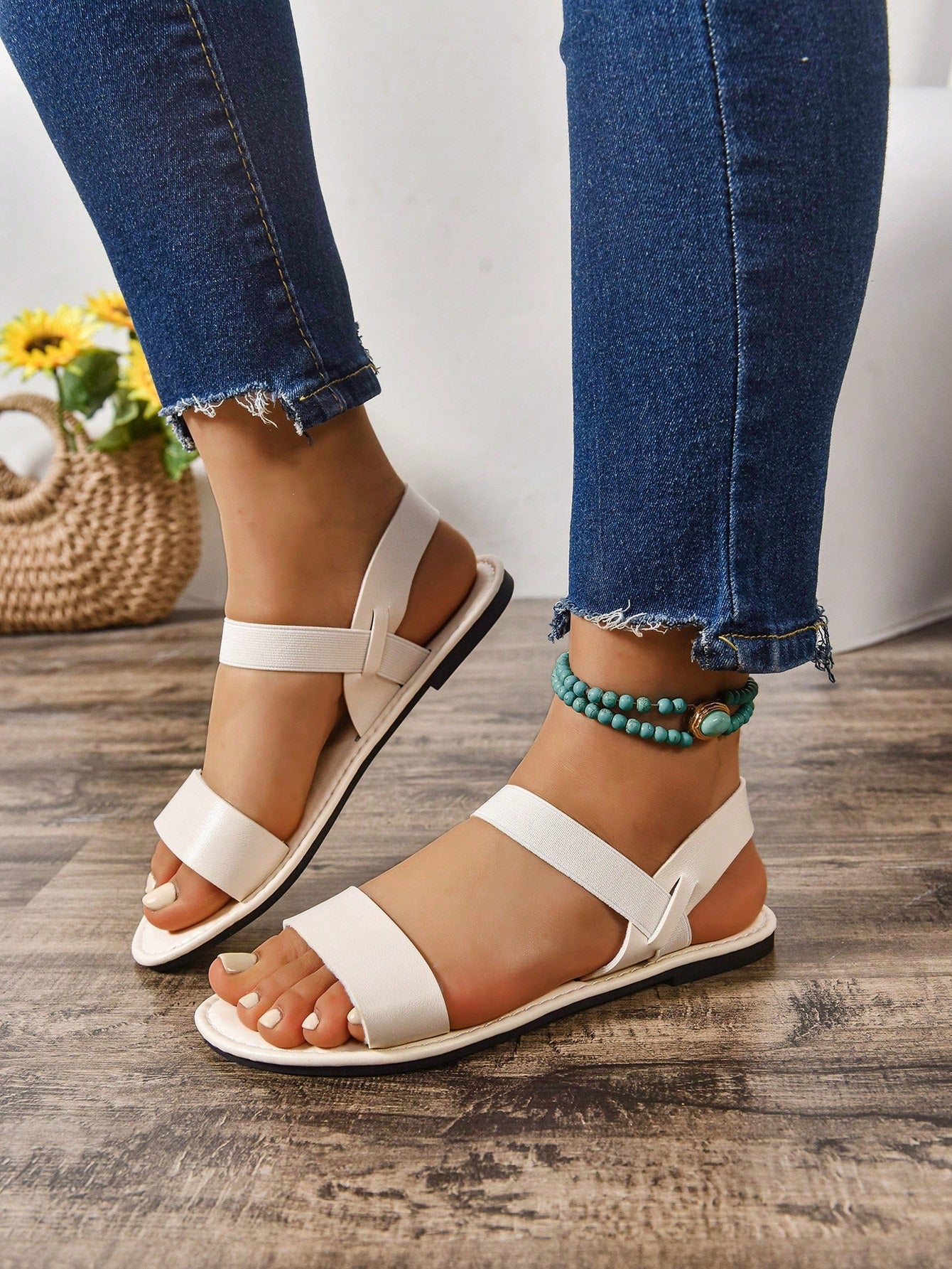 Women's wide fit flat gladiator sandals with woven textured straps, open toe, slip-on design, and lettuce trim detail.