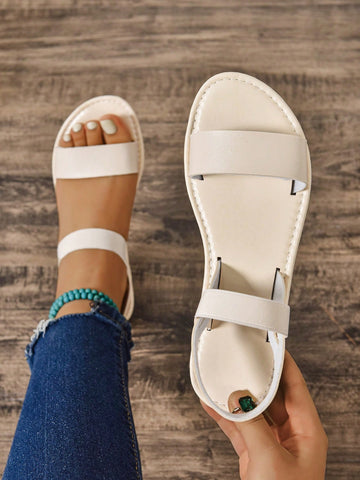Women's wide fit flat gladiator sandals with woven textured straps, open toe, slip-on design, and lettuce trim detail.