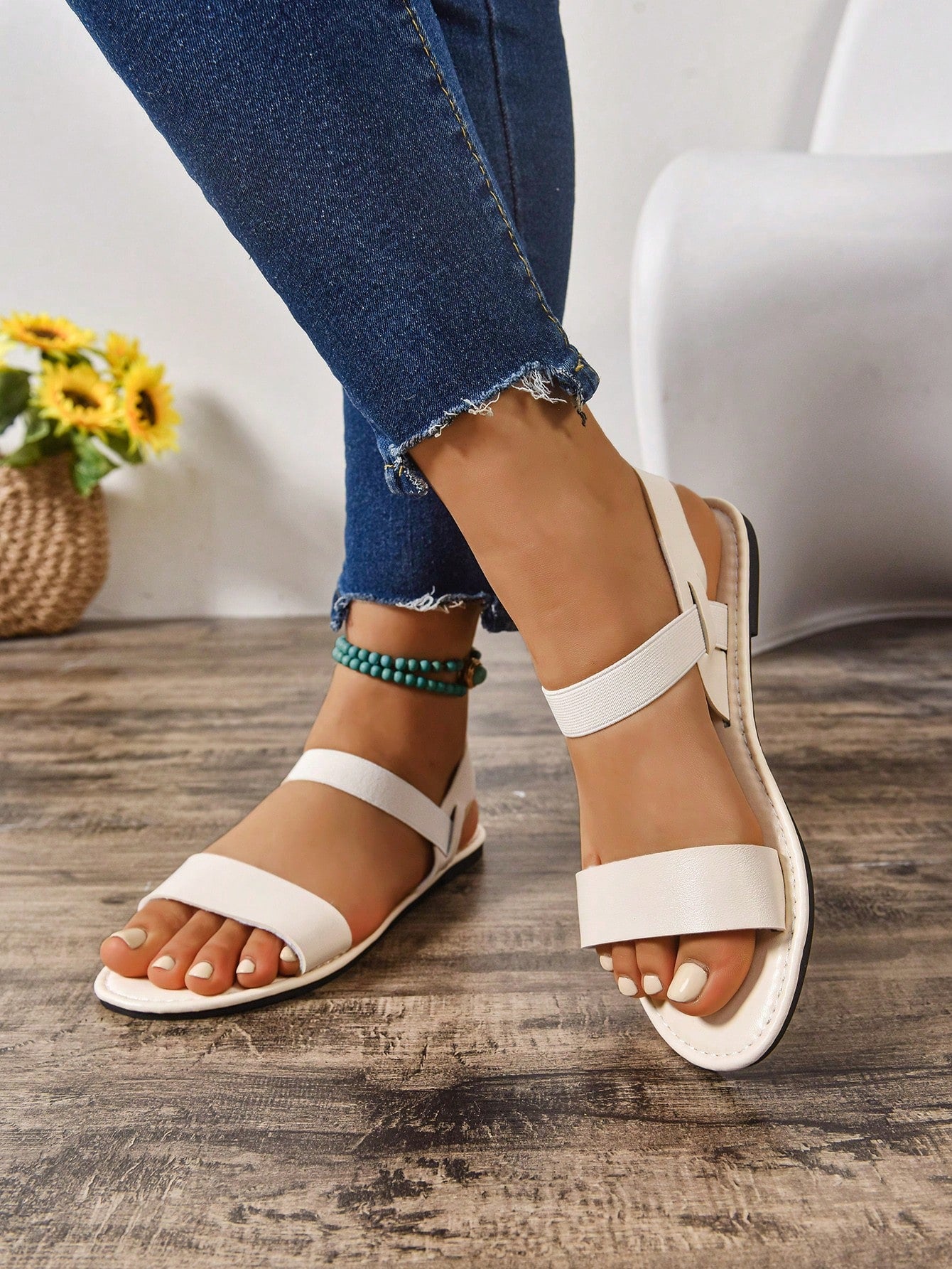 Women's wide fit flat gladiator sandals with woven textured straps, open toe, slip-on design, and lettuce trim detail.