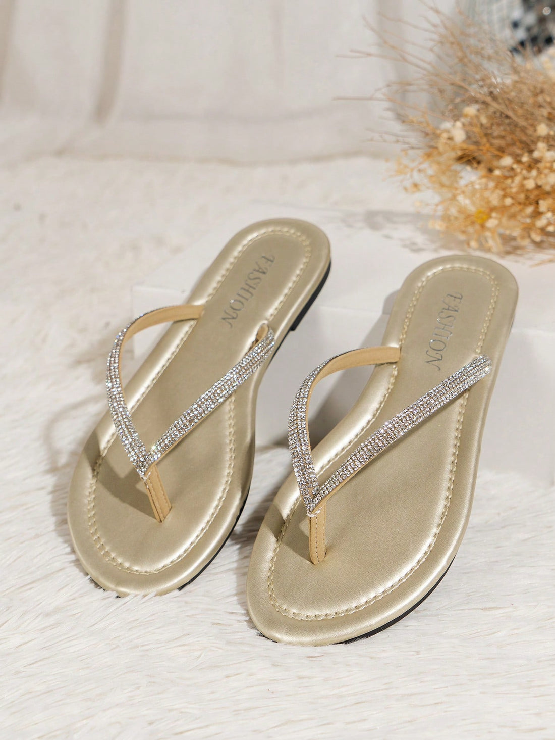 Women’s champagne flat thong slide sandals with rhinestone detail, plain pattern, and open-toe beach-ready style.
