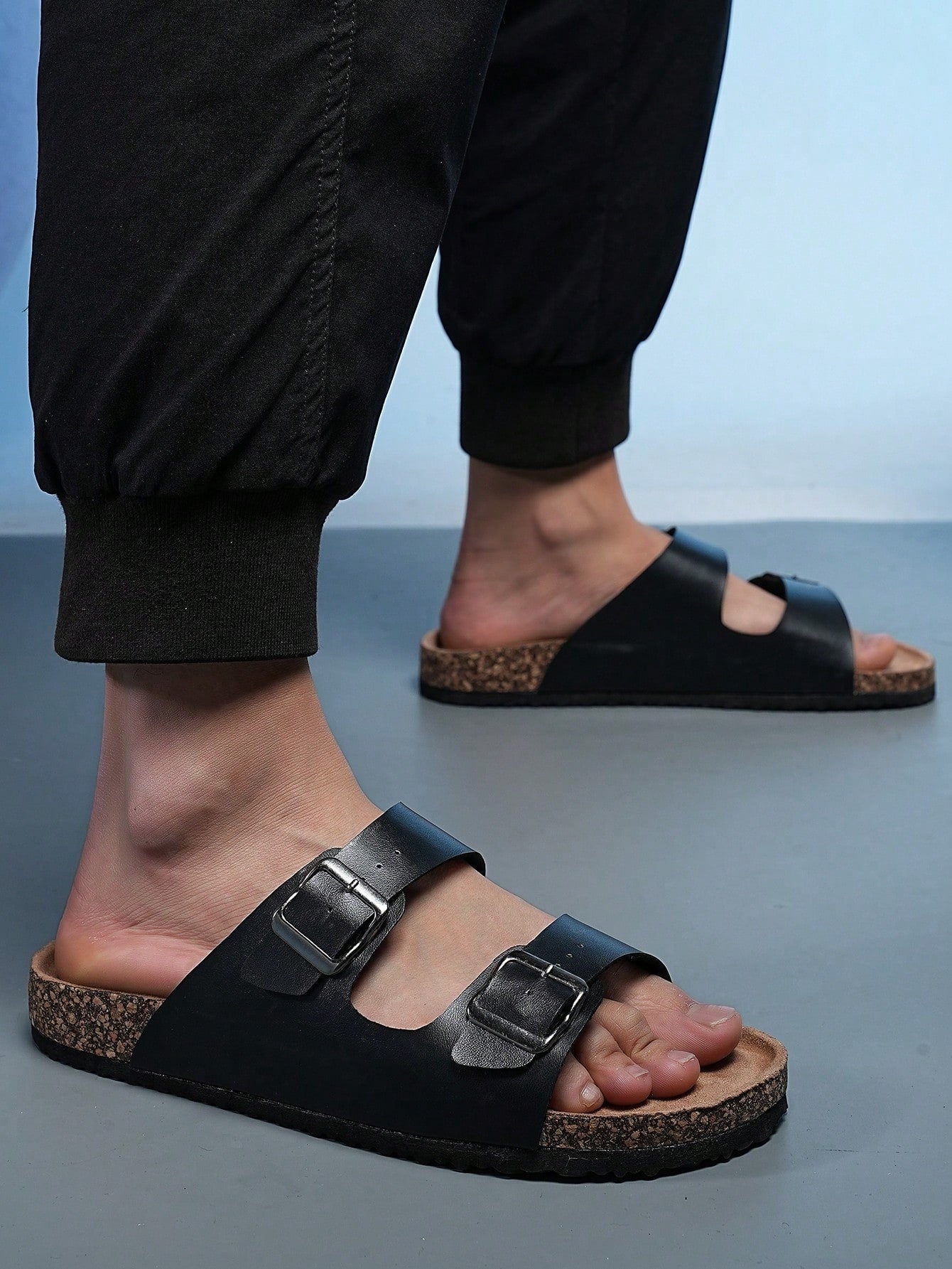 Open-toe footbed slip-on mule sandals with buckle detail and cork-style sole, flat heel design for casual summer home and outdoor walking.