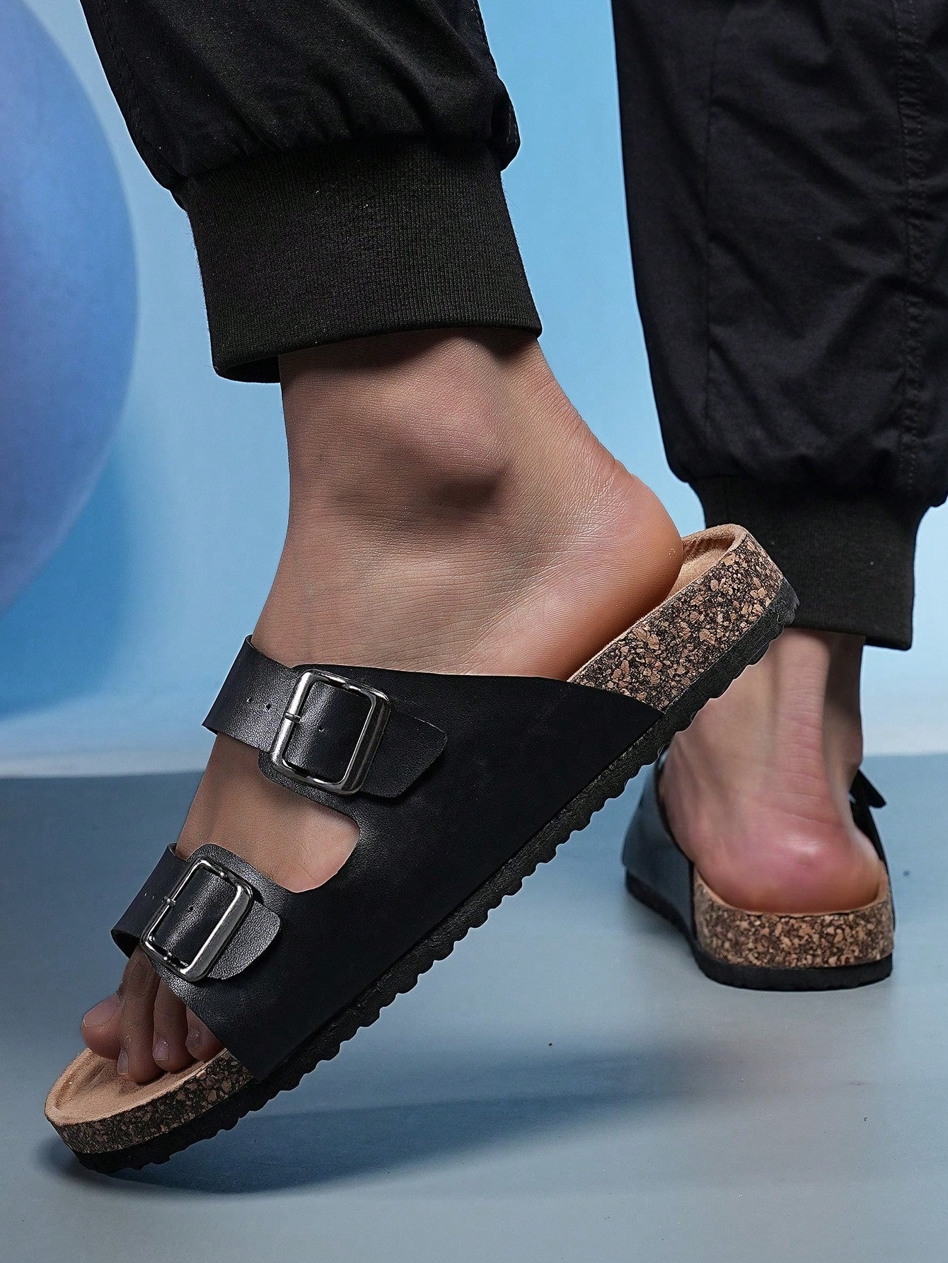 Open-toe footbed slip-on mule sandals with buckle detail and cork-style sole, flat heel design for casual summer home and outdoor walking.
