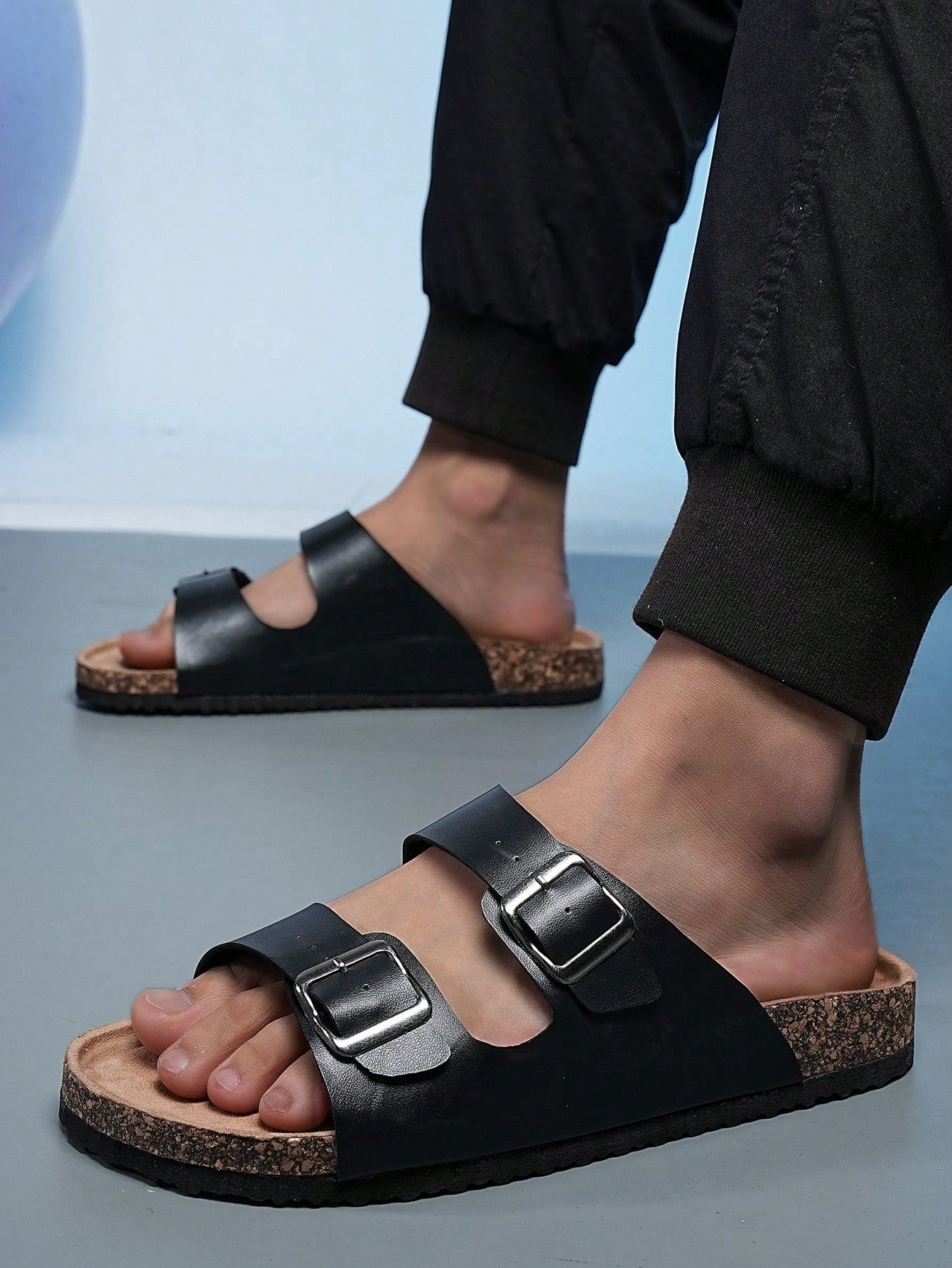 Open-toe footbed slip-on mule sandals with buckle detail and cork-style sole, flat heel design for casual summer home and outdoor walking.