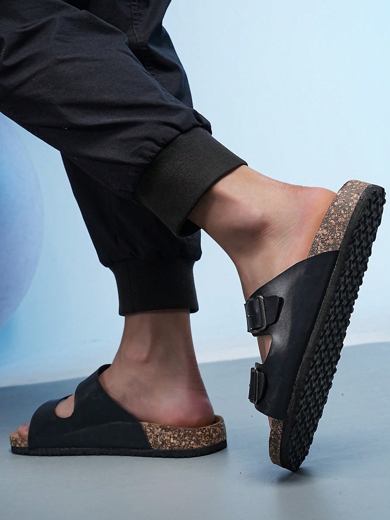Open-toe footbed slip-on mule sandals with buckle detail and cork-style sole, flat heel design for casual summer home and outdoor walking.