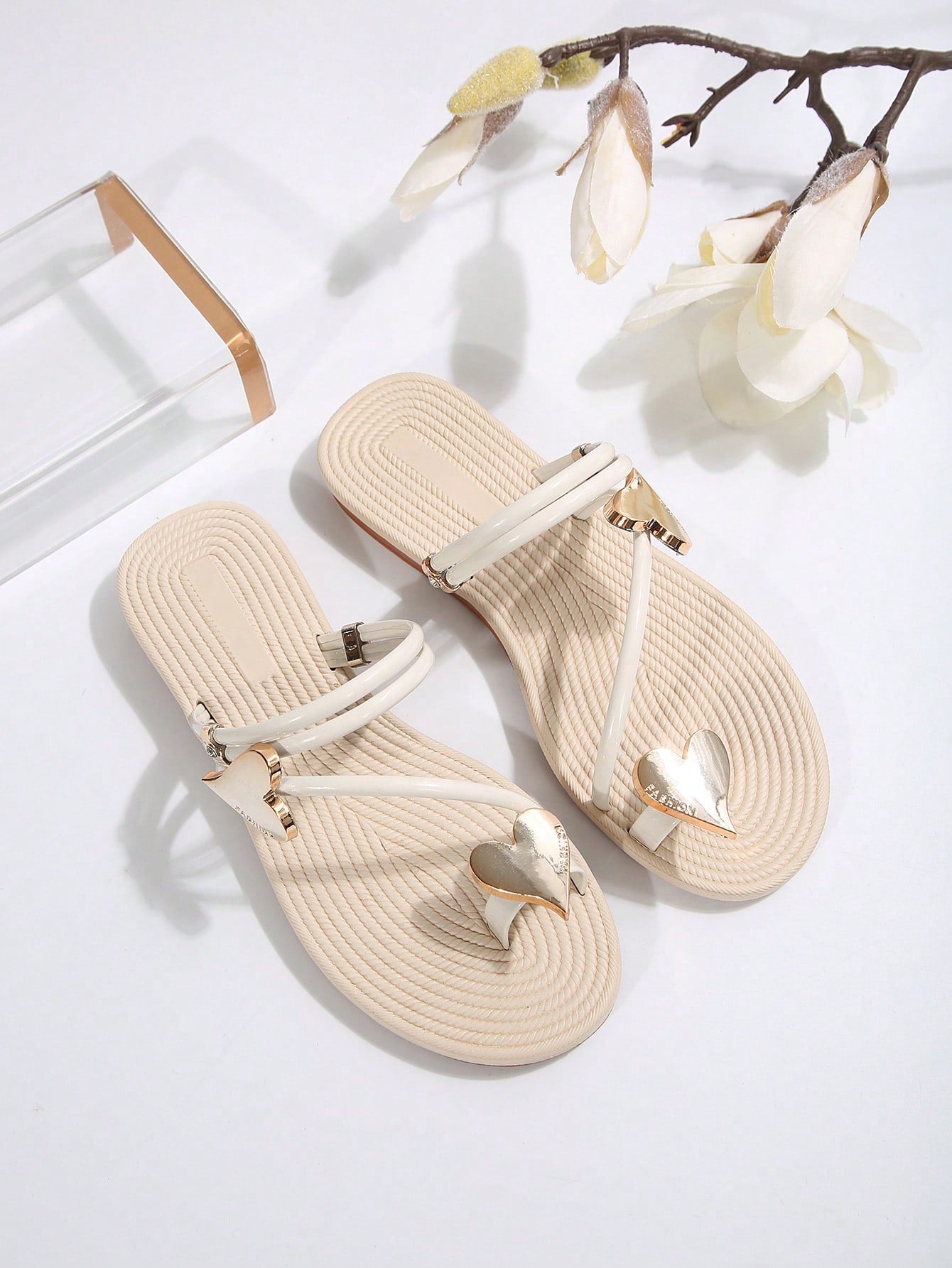 Women's open-toe strappy flat sandals with tasseled upper, seashell-inspired decoration, and rhinestone detail, designed for lightweight, comfortable beach and casual indoor or outdoor wear.