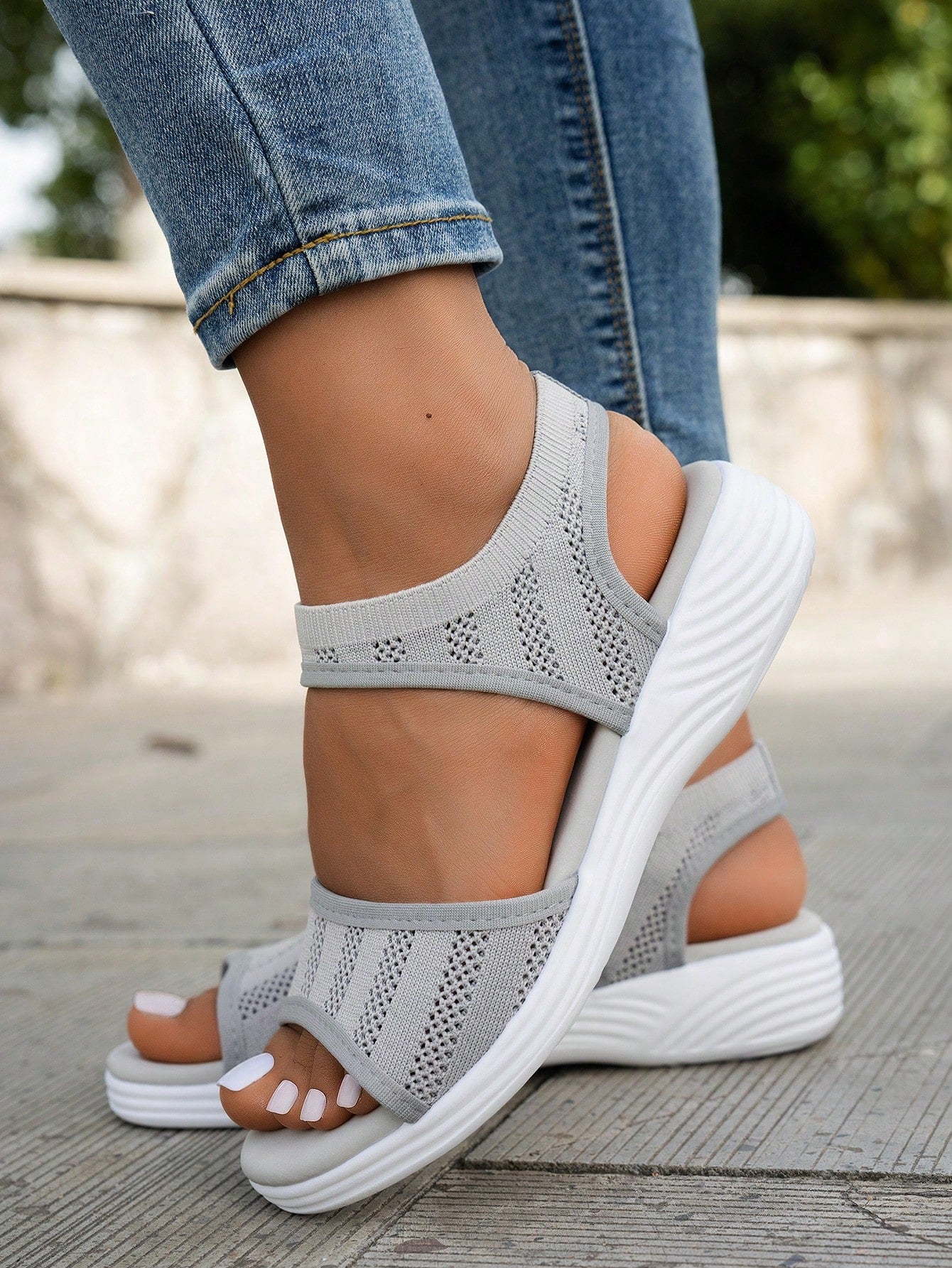Women's slip-on Roman style platform sandals with breathable cut-out upper, open toe, and flat outdoor-ready sole.