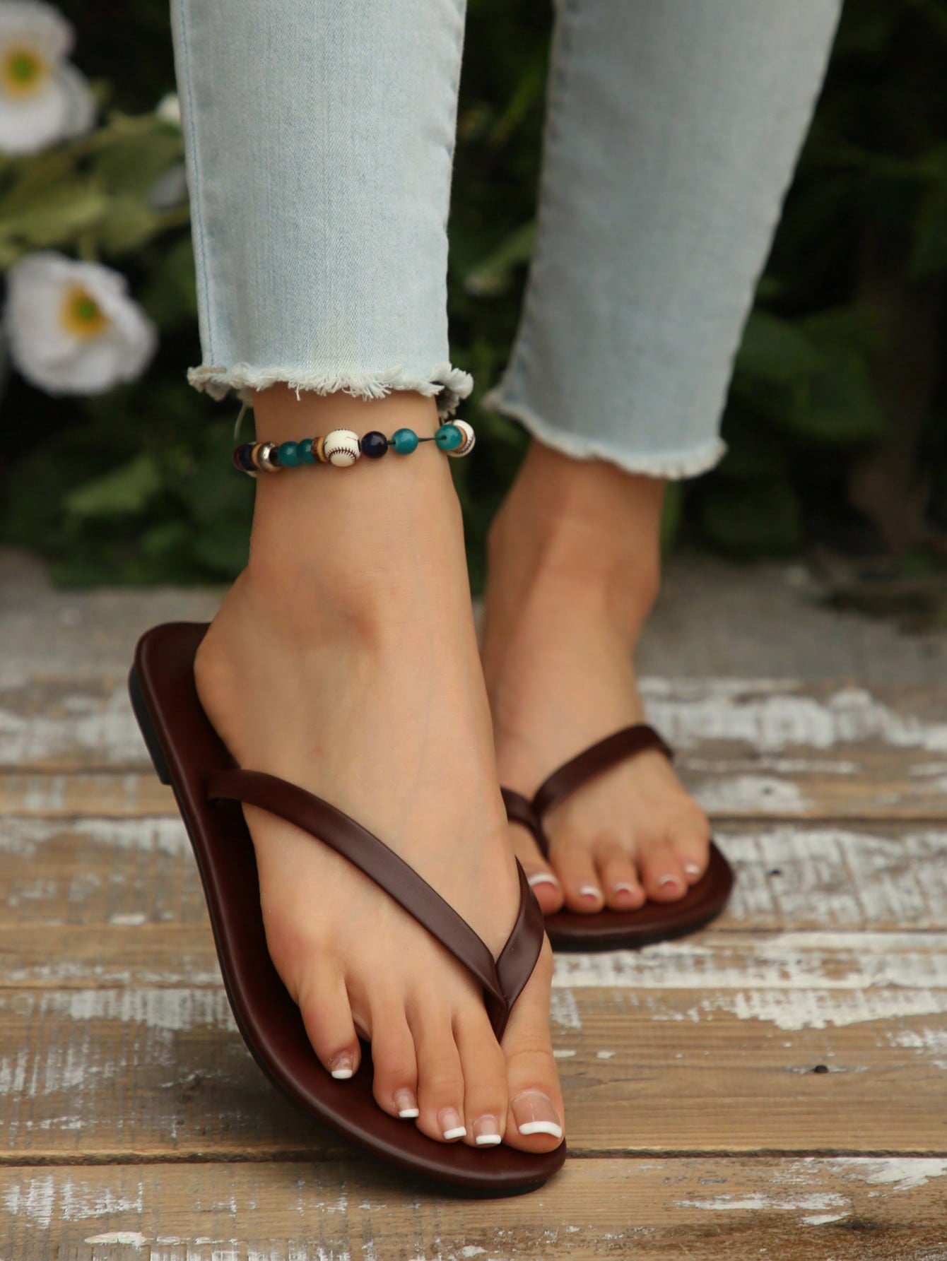 Women's chocolate brown flat flip flop sandals featuring a toe-post thong style and braided detail, suitable for casual indoor and outdoor wear.