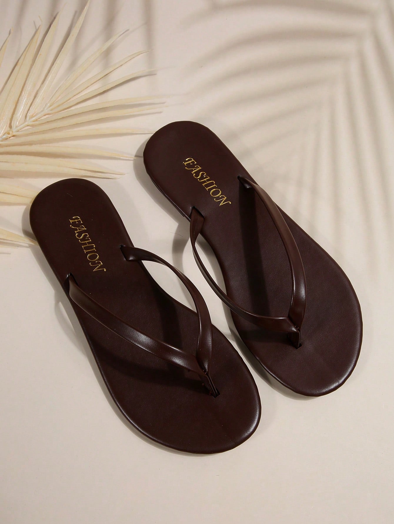 Women's chocolate brown flat flip flop sandals featuring a toe-post thong style and braided detail, suitable for casual indoor and outdoor wear.