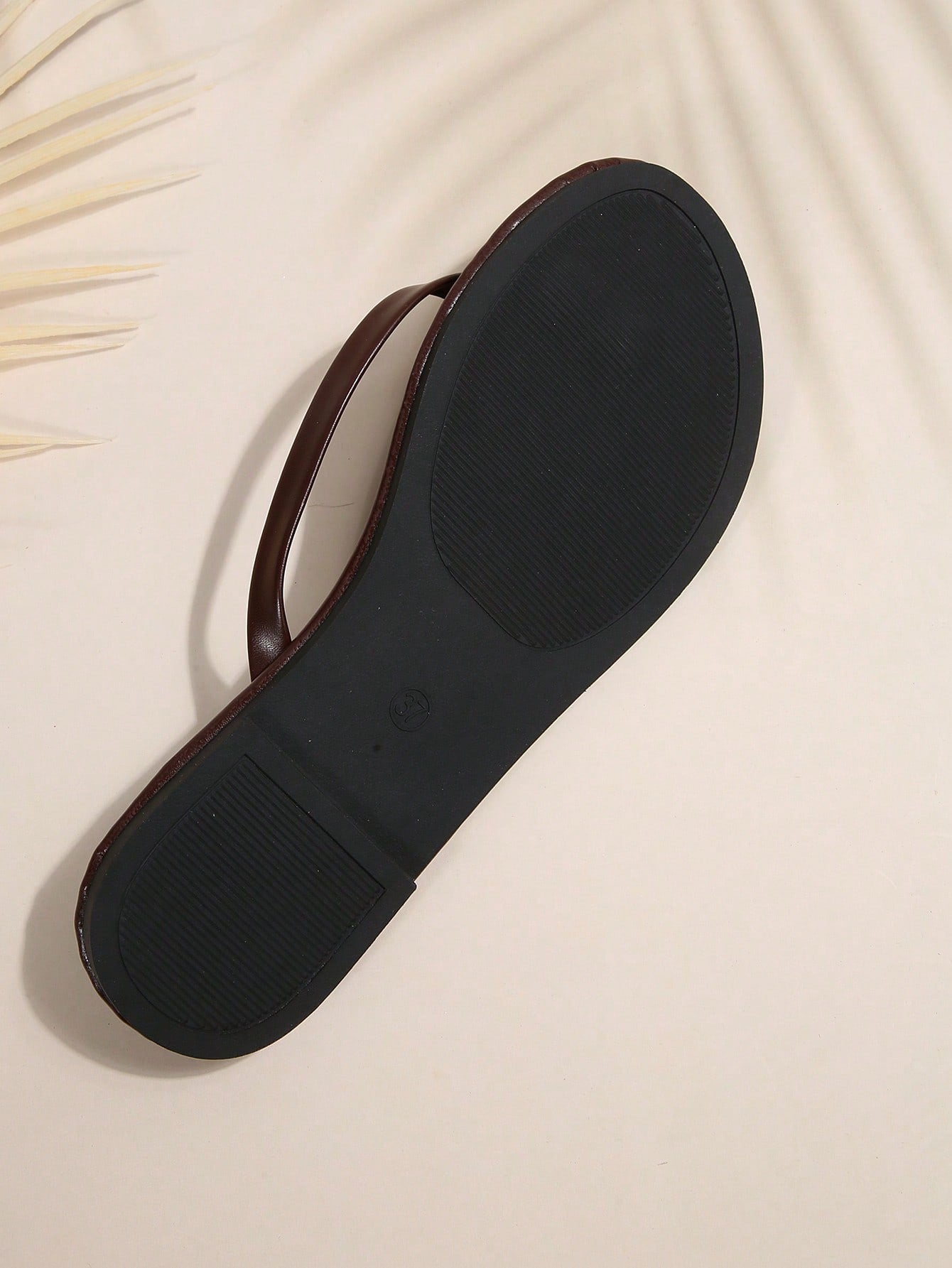 Women's chocolate brown flat flip flop sandals featuring a toe-post thong style and braided detail, suitable for casual indoor and outdoor wear.