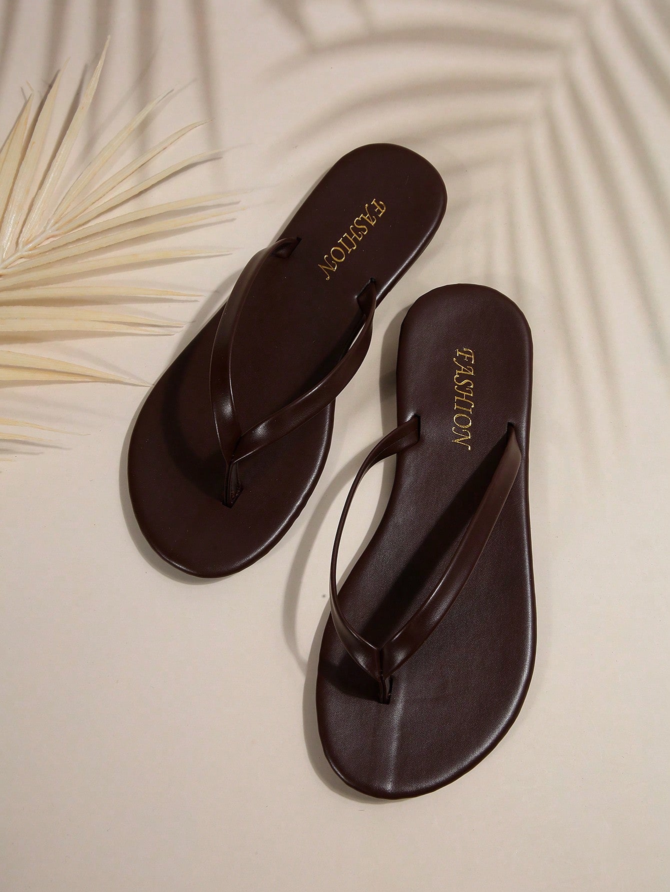 Women's chocolate brown flat flip flop sandals featuring a toe-post thong style and braided detail, suitable for casual indoor and outdoor wear.