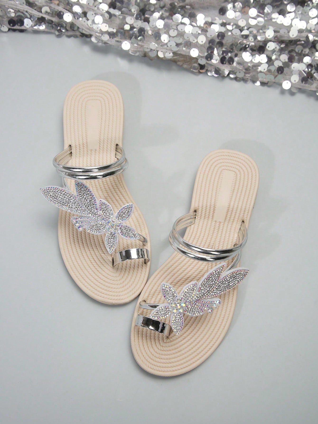 Women's flat slide sandals with crystal-style rhinestone and bow embellishments, toe post front, and beach-ready slip-on design.